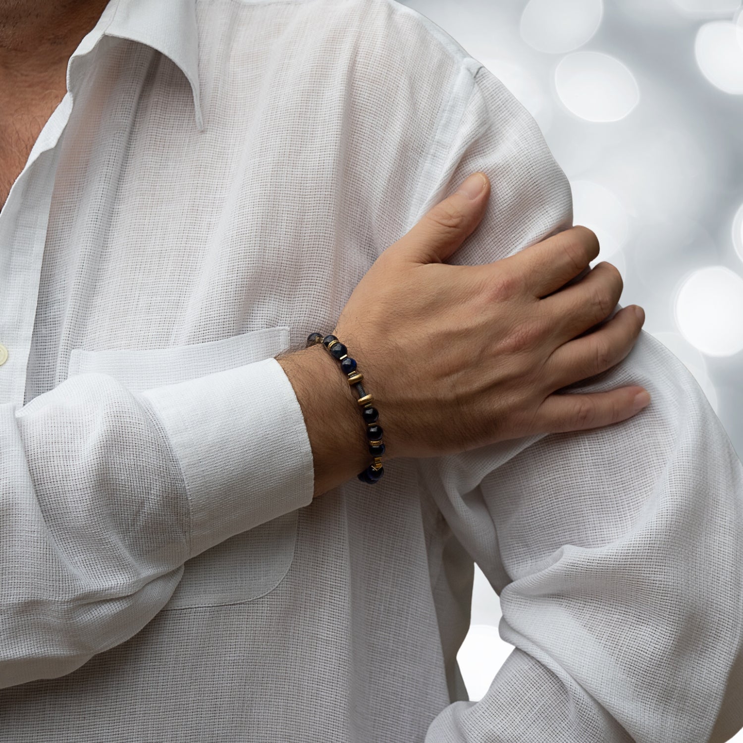 Unique men's bracelet with blue tiger's eye beads and a bronze dumbbell charm symbolizing strength and dedication