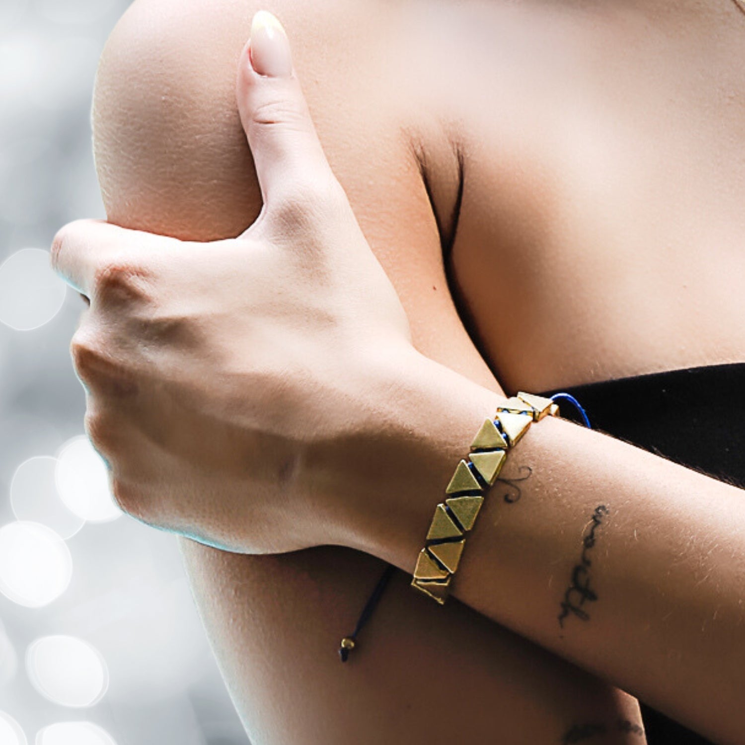 Model Showcasing Calming Blue Woven Gold Bracelet - Geometric Design