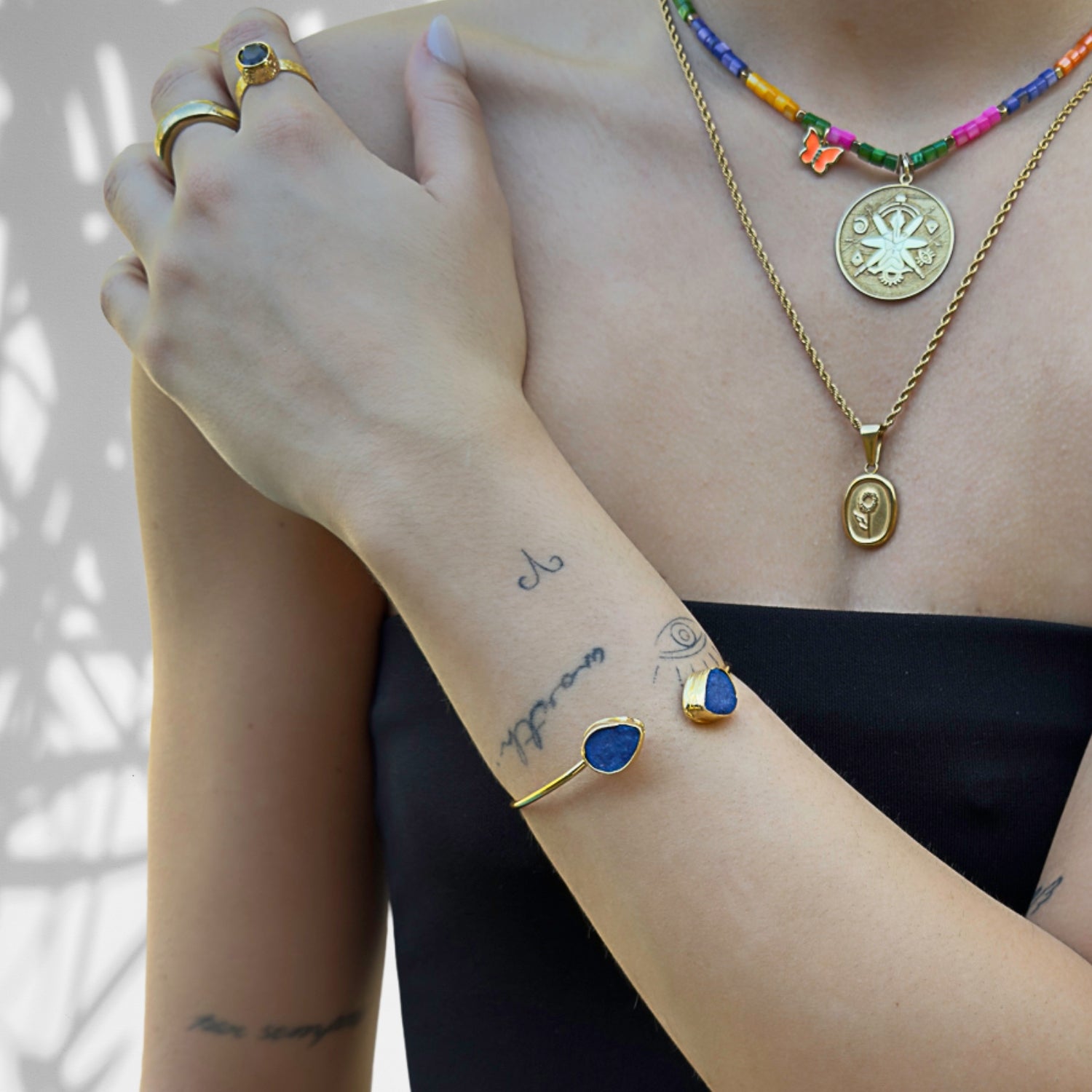 Elegant gold cuff bracelet featuring blue Druzy Agate stones
