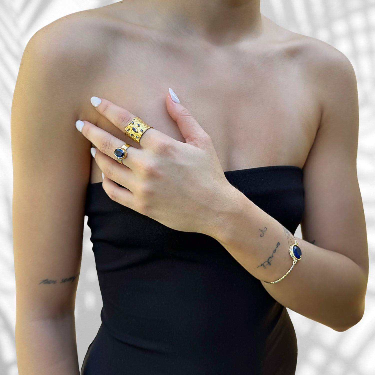 close up of blue sapphire stone on 24K gold-plated ring