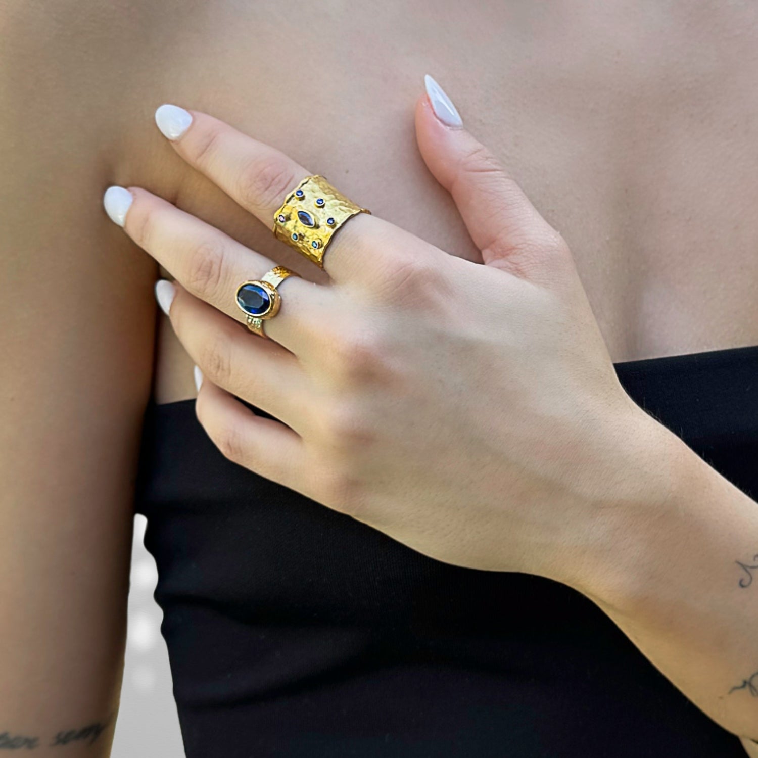 detailed view of blue sapphire and 24K gold-plated band