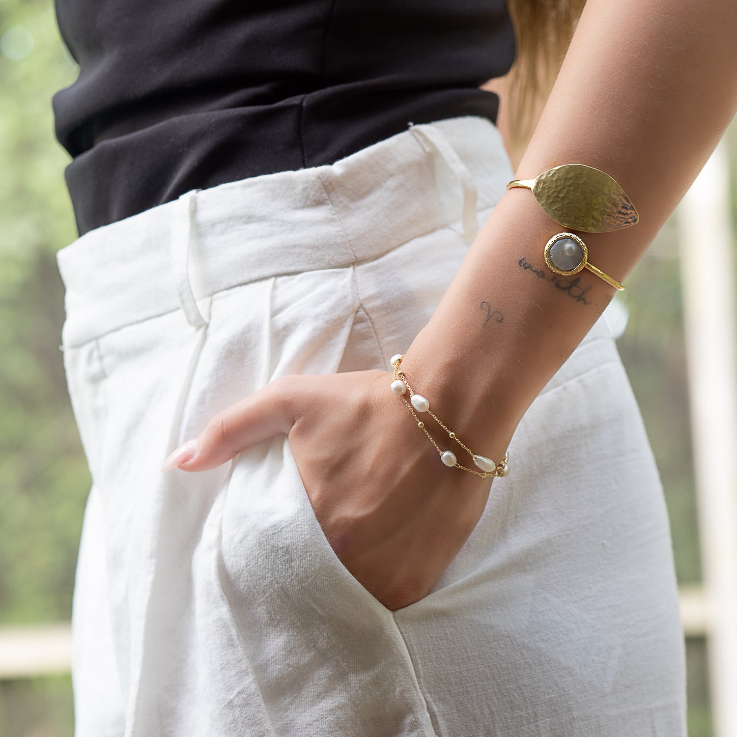 Model radiates elegance with the Cleopatra Gold Leaf & Pearl Stone Cuff Bracelet.