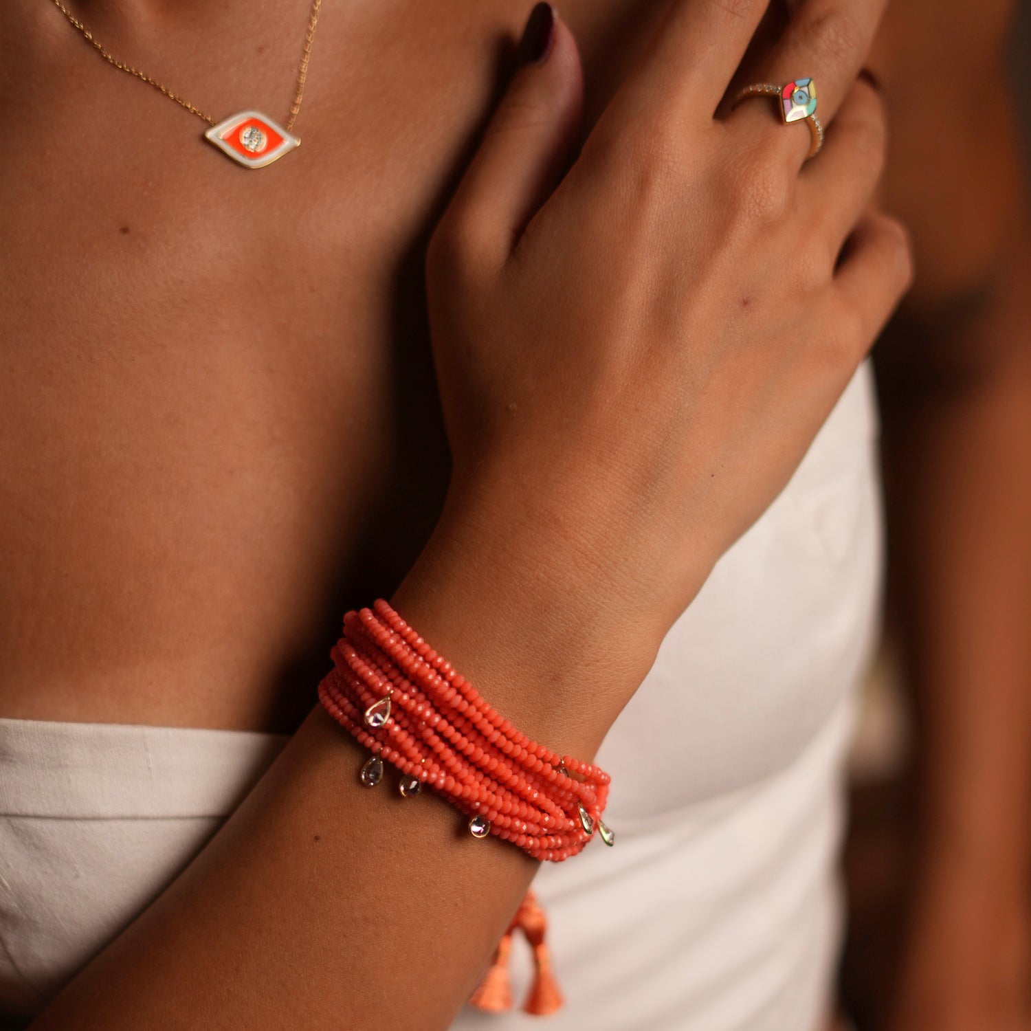 Vibrant orange crystal bead bracelet with silver charms and adjustable multi-strand design