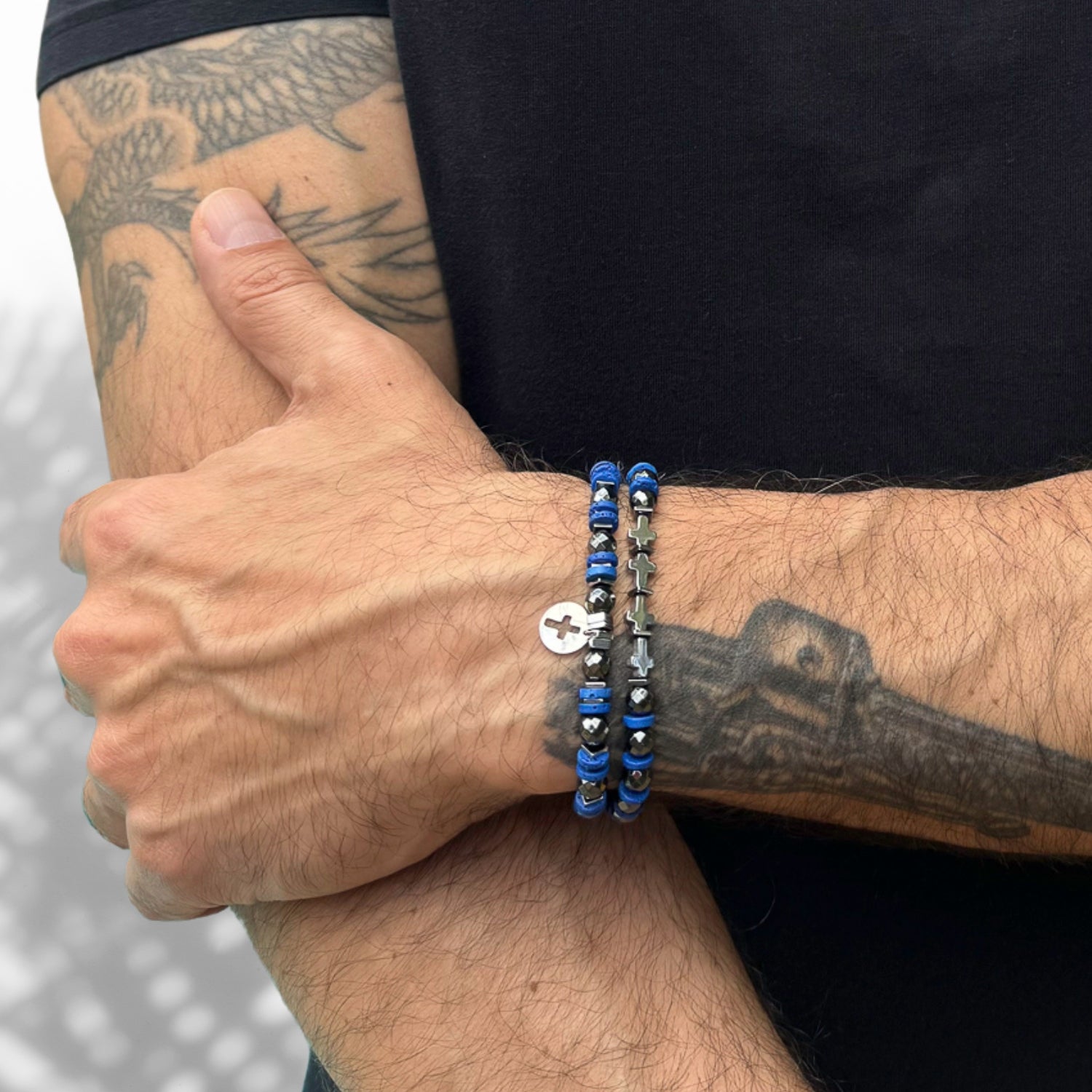 Handcrafted bracelet set with hematite beads, blue nugget lava rock stones, and a 925 sterling silver cross charm for spiritual elegance