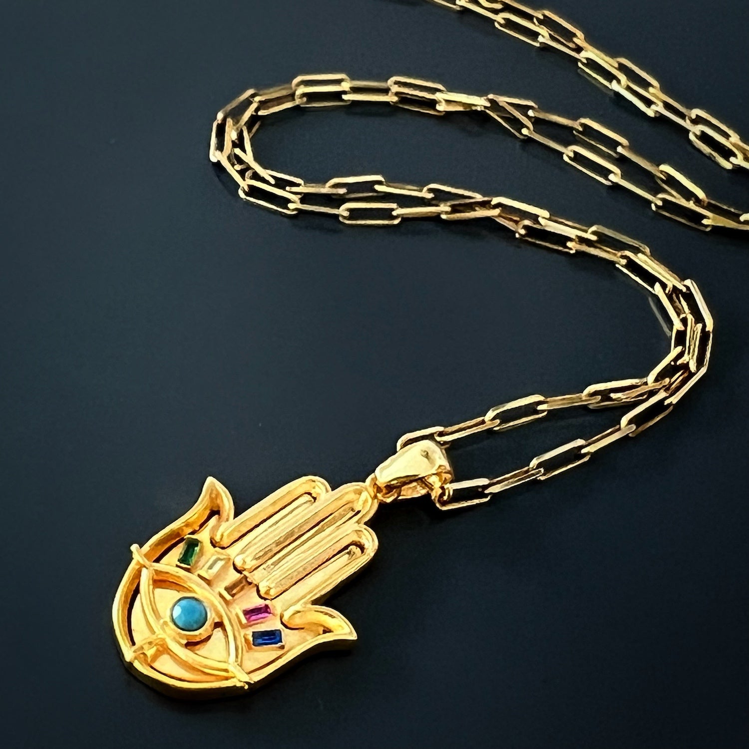 Gold Hamsa Pendant Necklace - Embrace the protective energy of this gold Hamsa pendant necklace, complete with a vibrant turquoise stone and shimmering zircon accents.