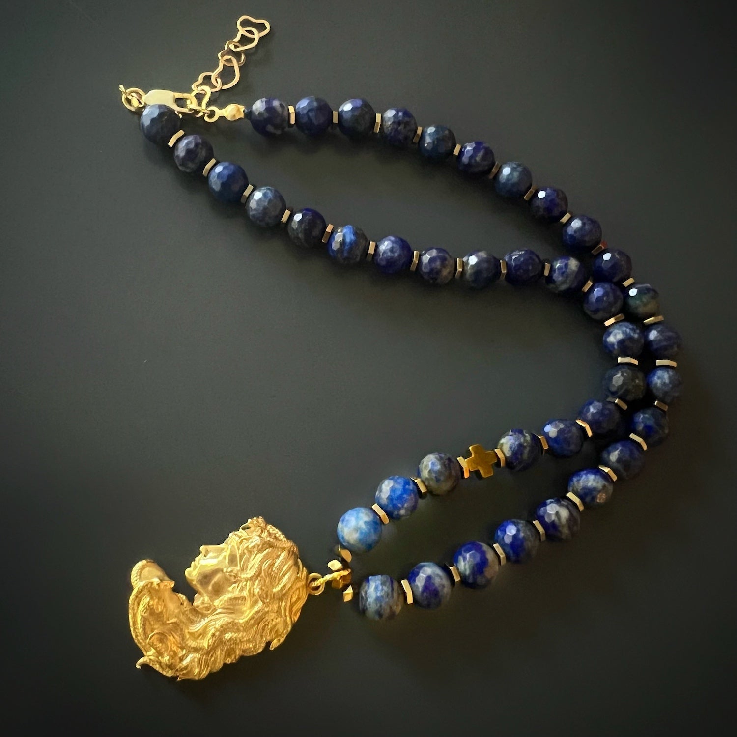 Discover the opulence of the Medusa Lapis Lazuli Necklace, adorned with gold hematite spacers and a captivating handmade pendant.
