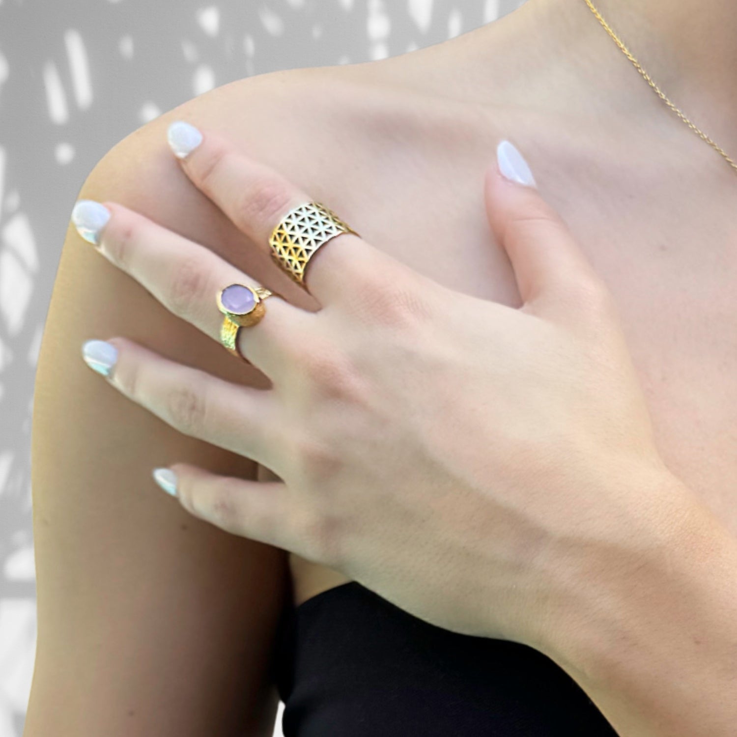 Showcasing the intricate geometric design on an 18k gold-plated sterling silver band, perfect for adding a bold statement to any outfit.