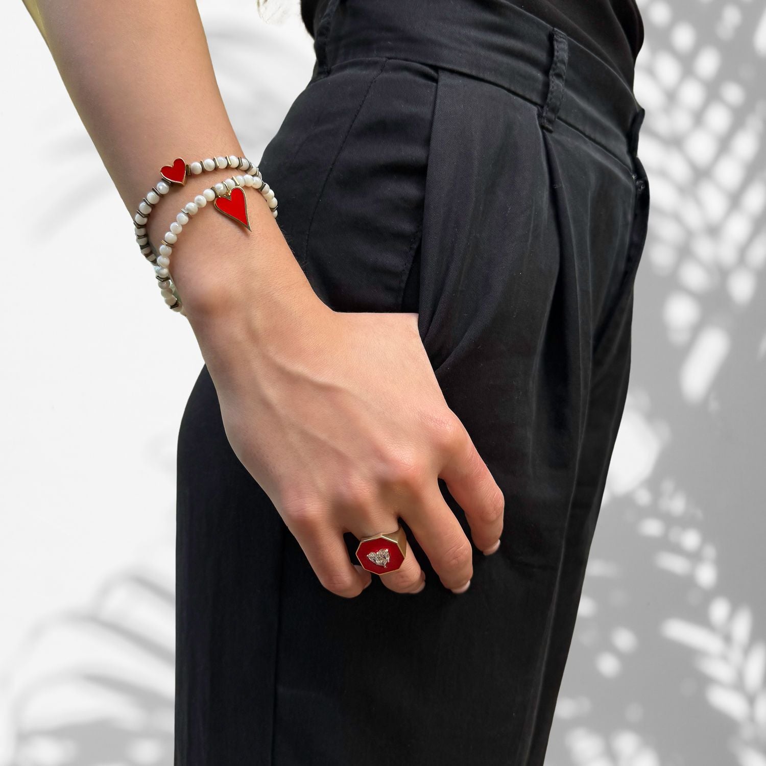 Model Wearing Elegant White Beaded Bracelet with Red Hearts