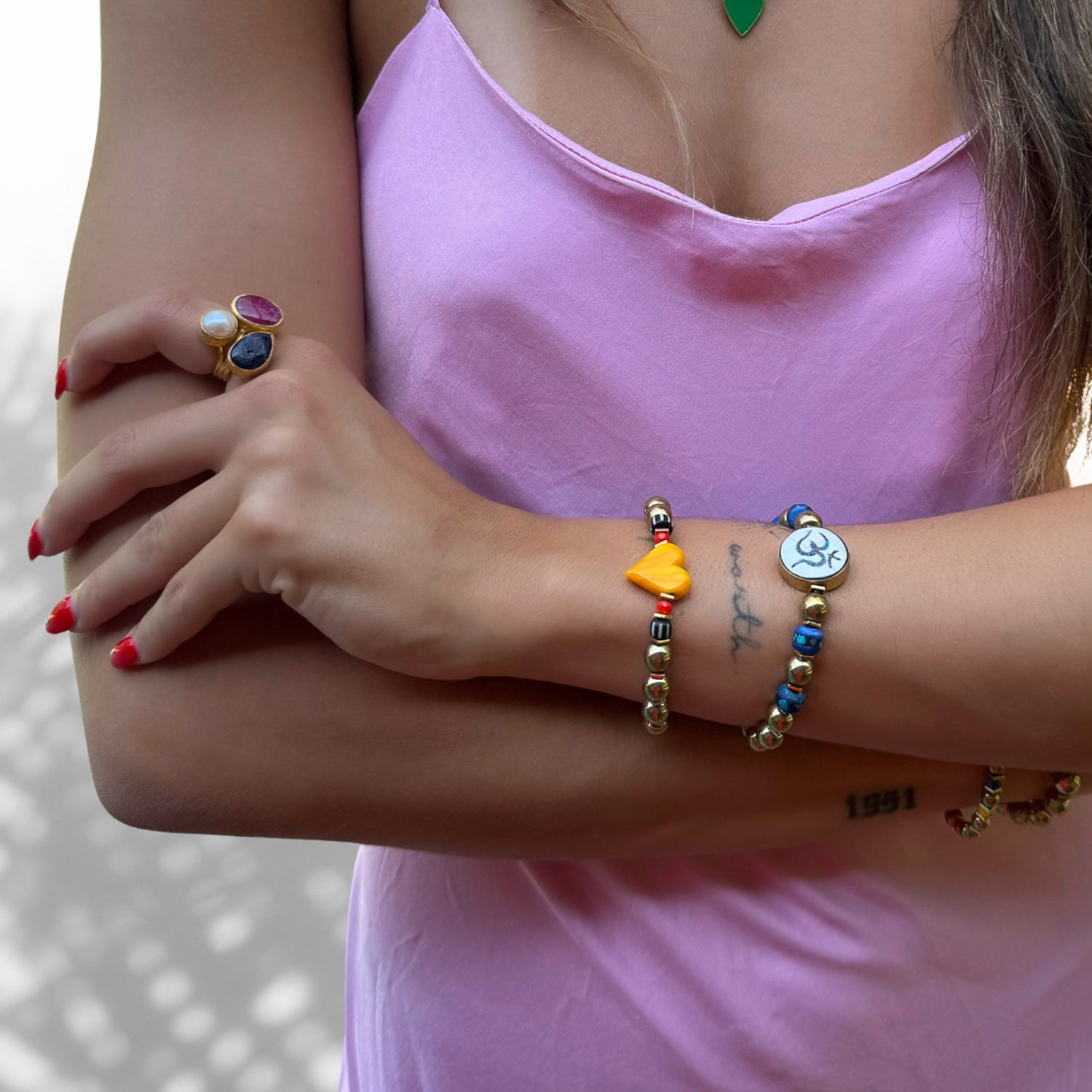 Model Wearing Handmade Gold Beaded Bracelet with Om Mantra Charm