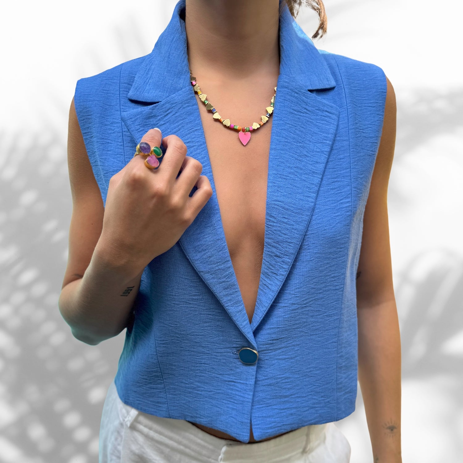 Model Wearing Handmade Colorful Necklace with Gold and Pink Heart Pendants