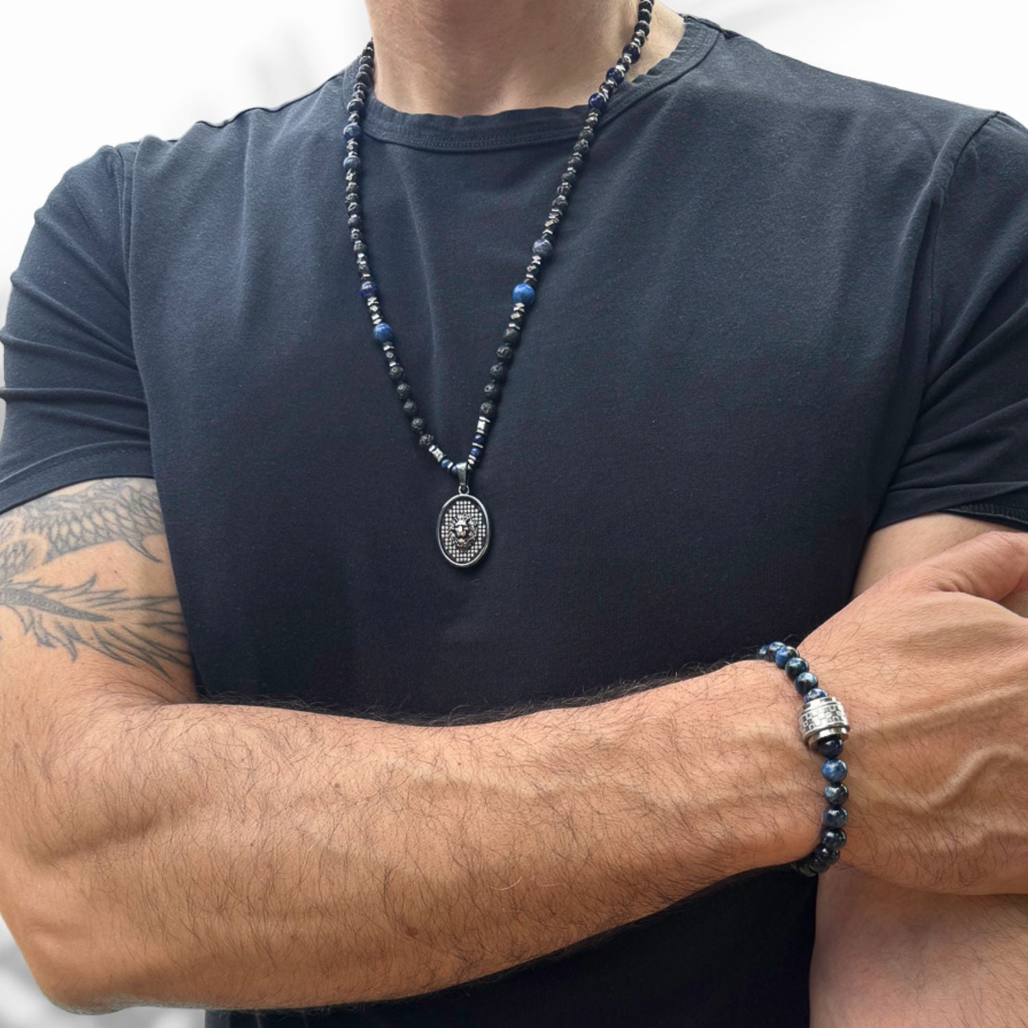 Powerful beaded necklace featuring lava rock, hematite, lapis lazuli, and silver lion charm.
