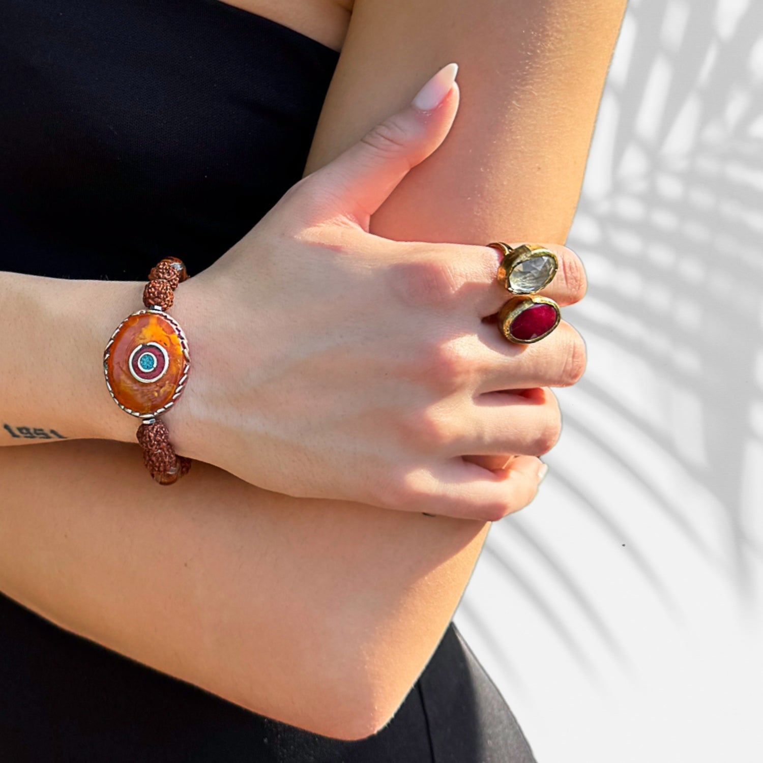close up of rudraksha seed beads and large Nepal eye bead on bracelet