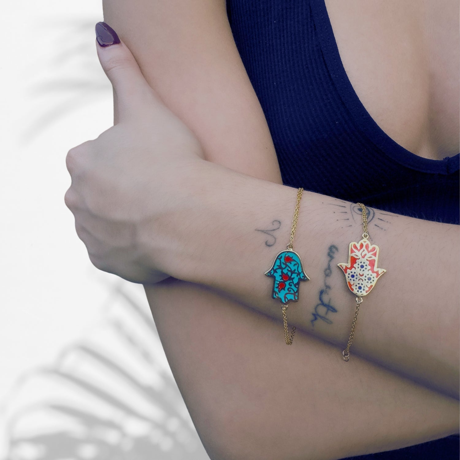 Handcrafted Hamsa Hand Bracelet featuring red enamel and floral accents.