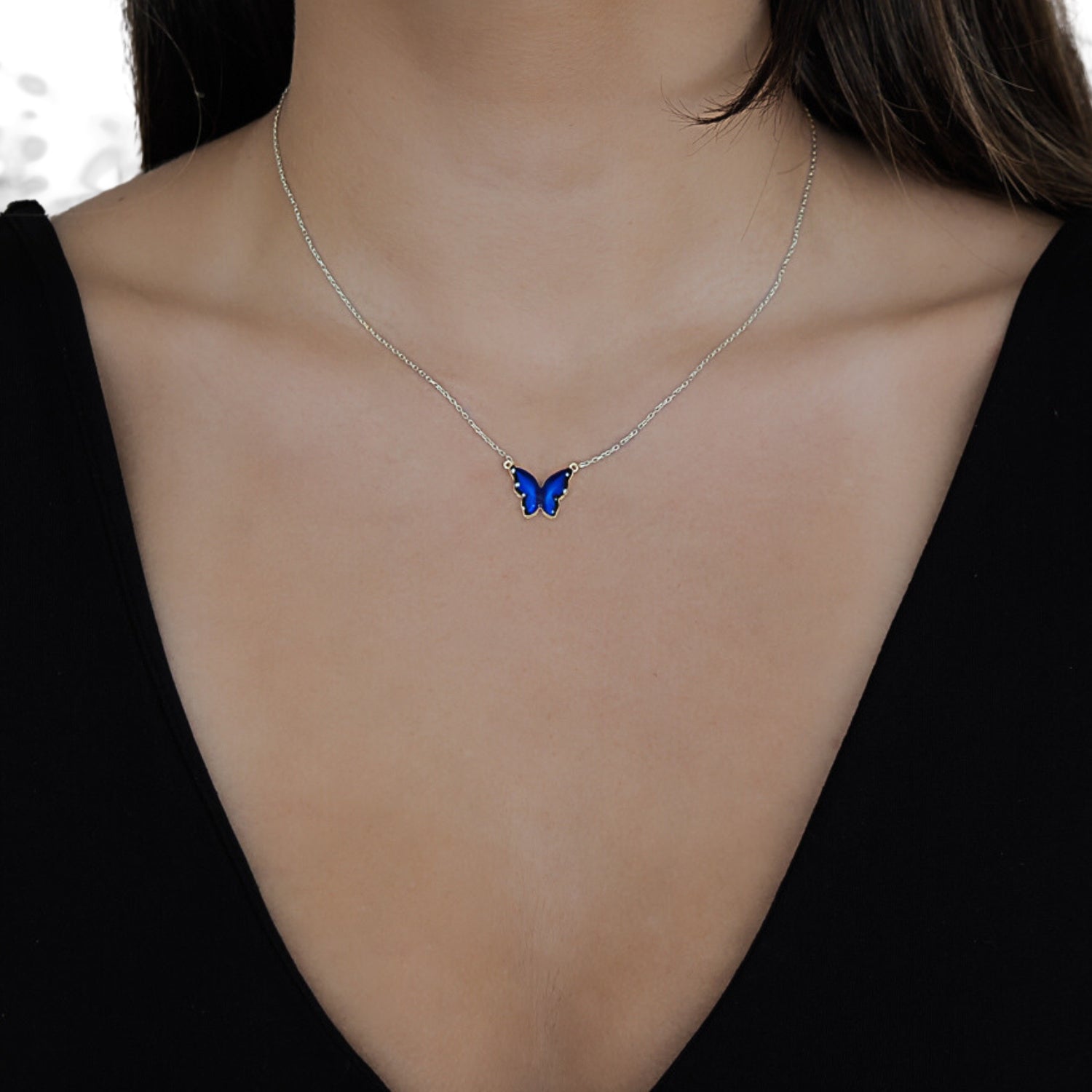 Model wearing the Silver Spiritual Blue Enamel Butterfly Necklace, radiating confidence and embracing the symbolism of transformation.