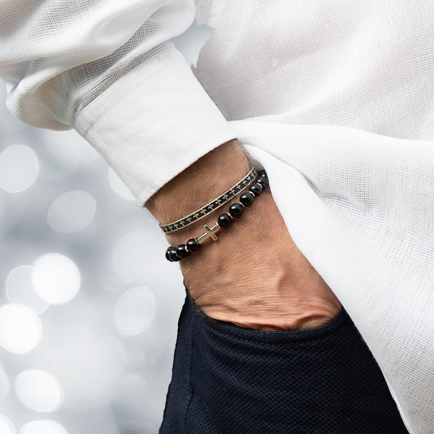 Men's beaded bracelet with black onyx stones and a sterling silver cross charm