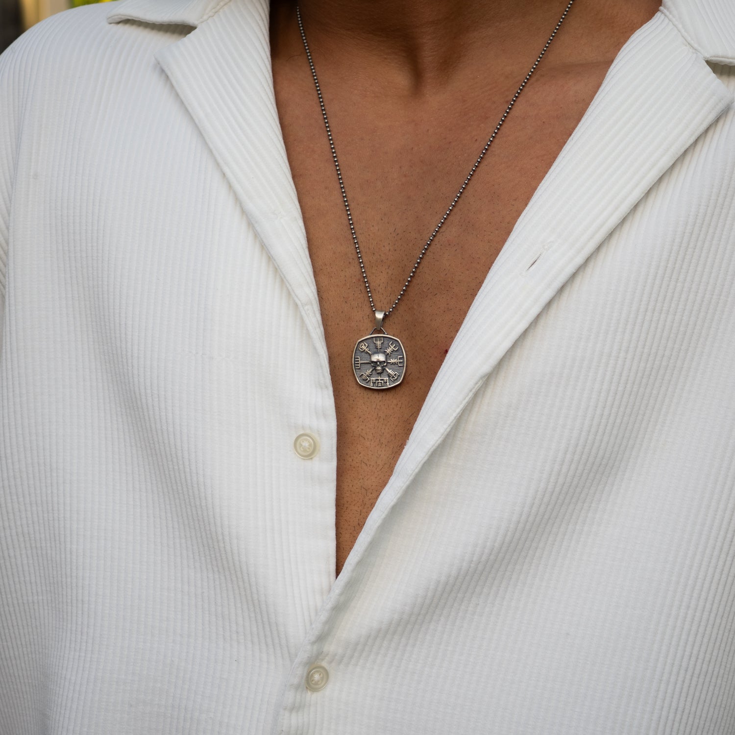Sterling silver Viking necklace with Vegvisir symbol and skull pendant, handmade for strength.