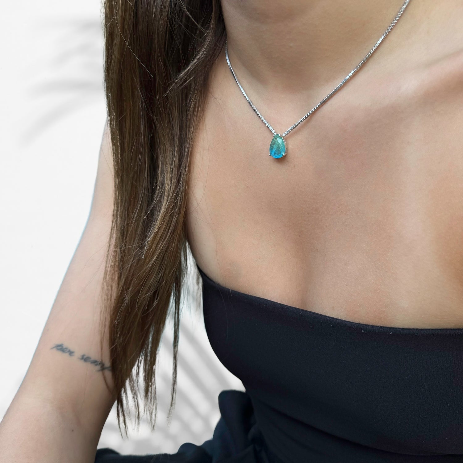 Model Wearing Handmade Brilliance: Sterling Silver Necklace with Rare Gemstone