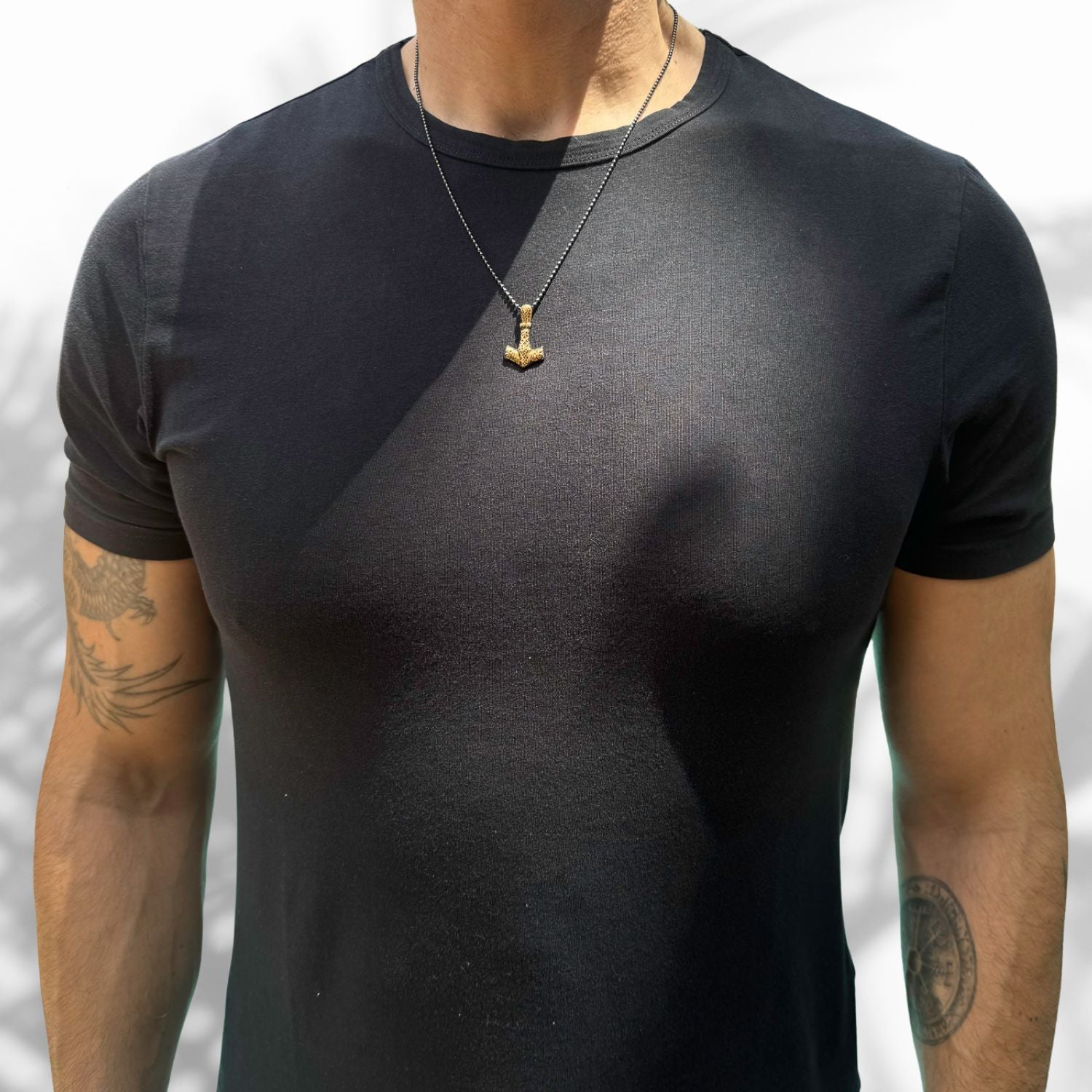 Thor hammer pendant necklace in 24k gold-plated sterling silver, symbolizing power and protection.