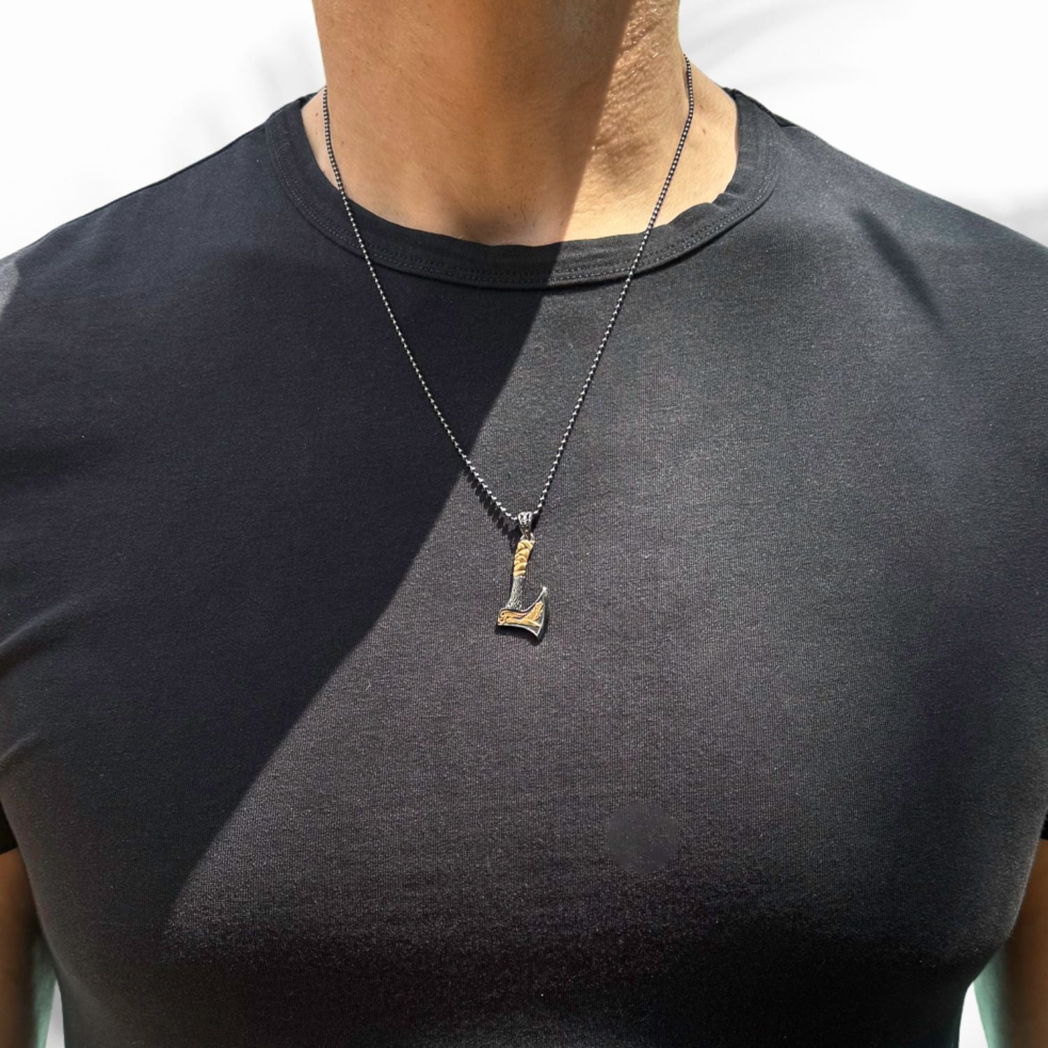 Norse axe men necklace with handcrafted gold and silver pendant symbolizing Viking bravery.