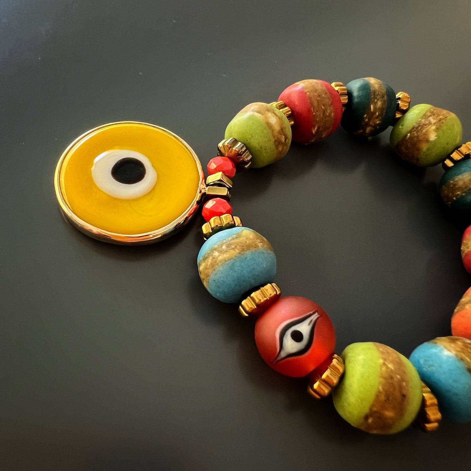 Add a touch of sunshine to your style with the Yellow Evil Eye Carpe Diem Bracelet, a statement piece that exudes positivity and warmth.