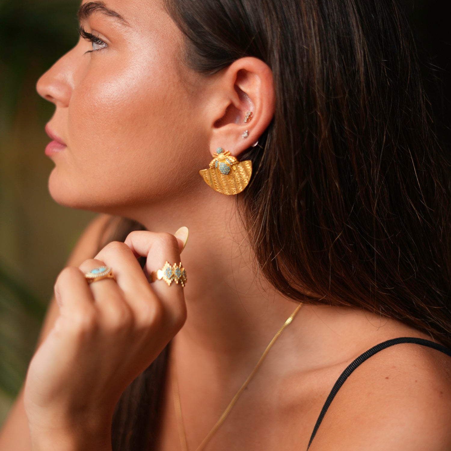 Sophisticated 24k gold-plated earrings with a half-moon shape, turquoise embellishments, and a detailed honey bee, combining elegance and meaning.