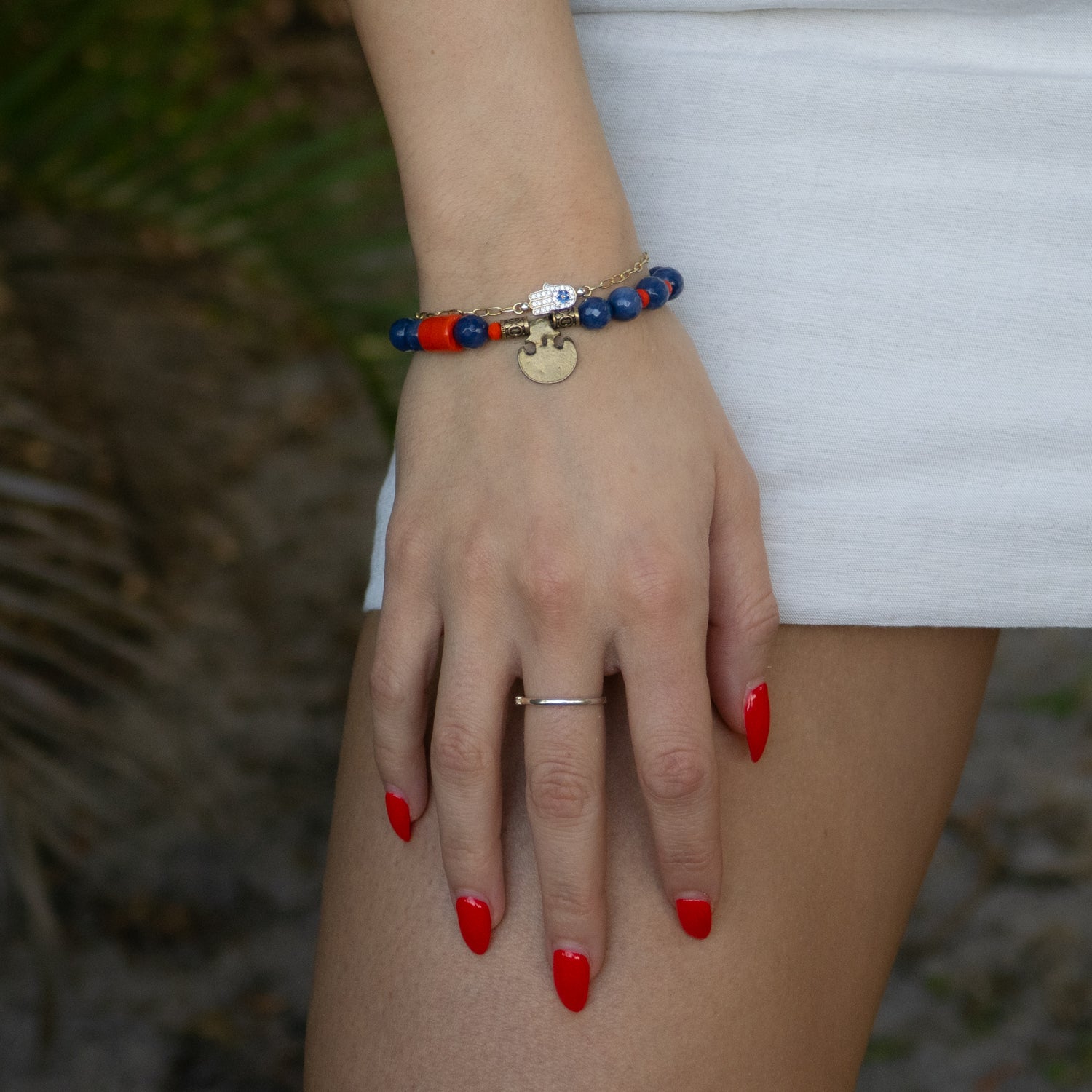 Blue Agate stone bracelet with orange crystal beads and bronze charm accent.