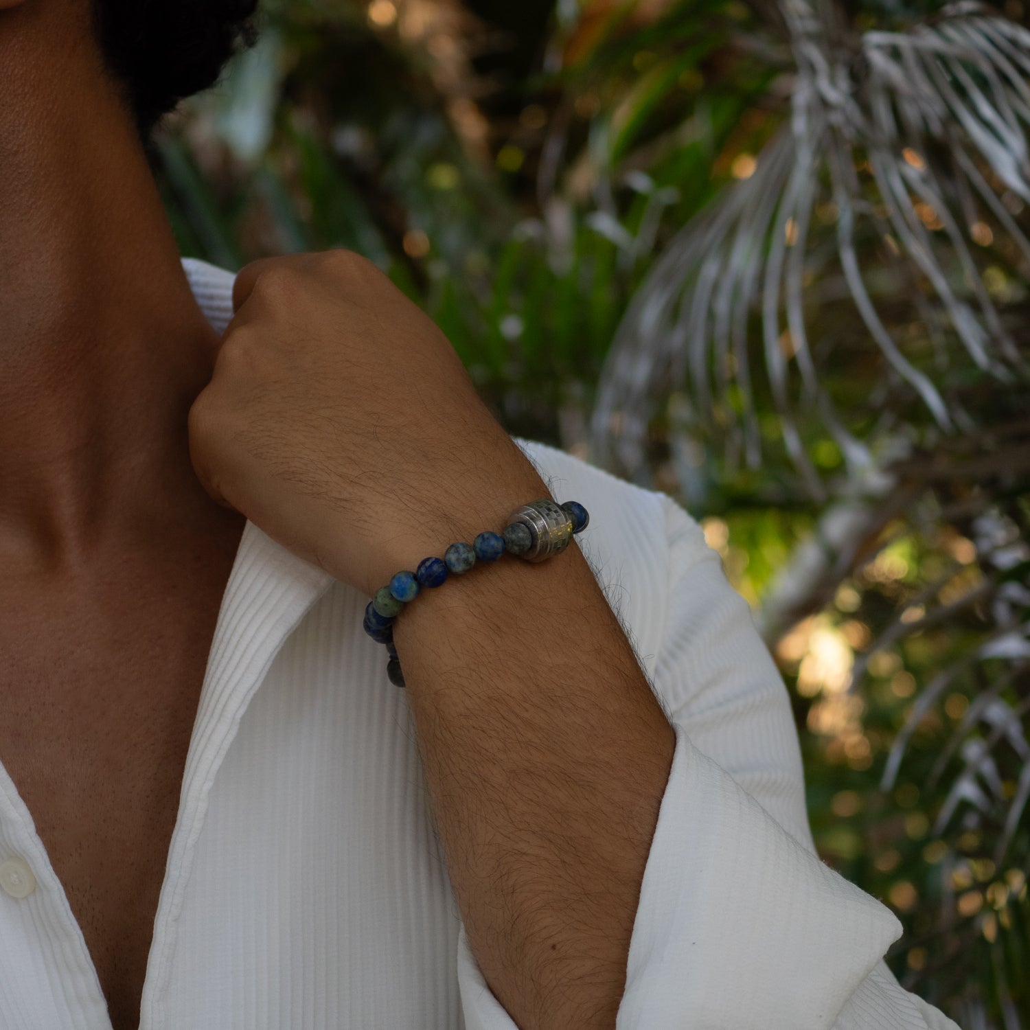 Matte azurite beaded bracelet with large steel Amor accent bead and silver hematite cross.