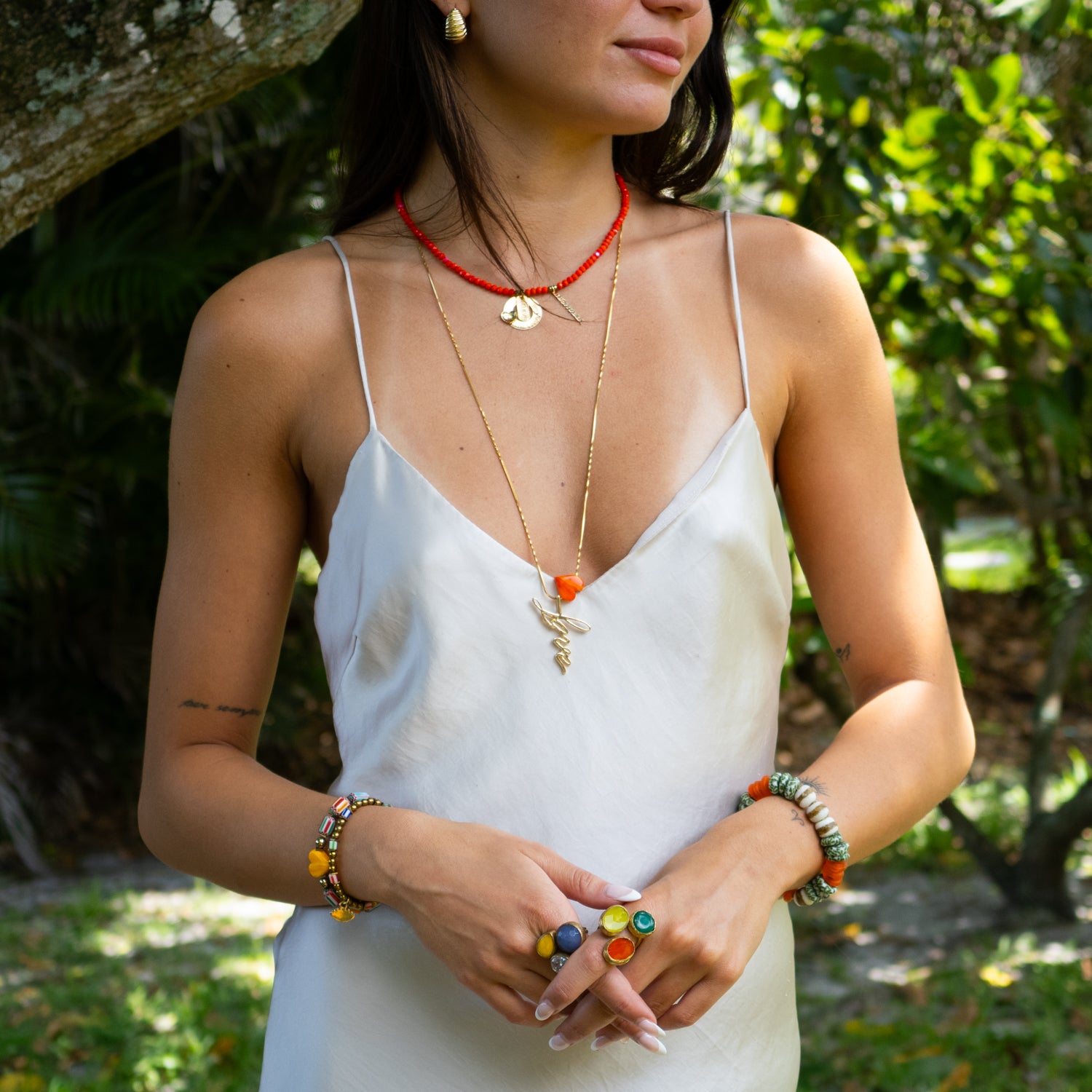Uplifting choker with faceted red crystal beads and motivational gold charms.