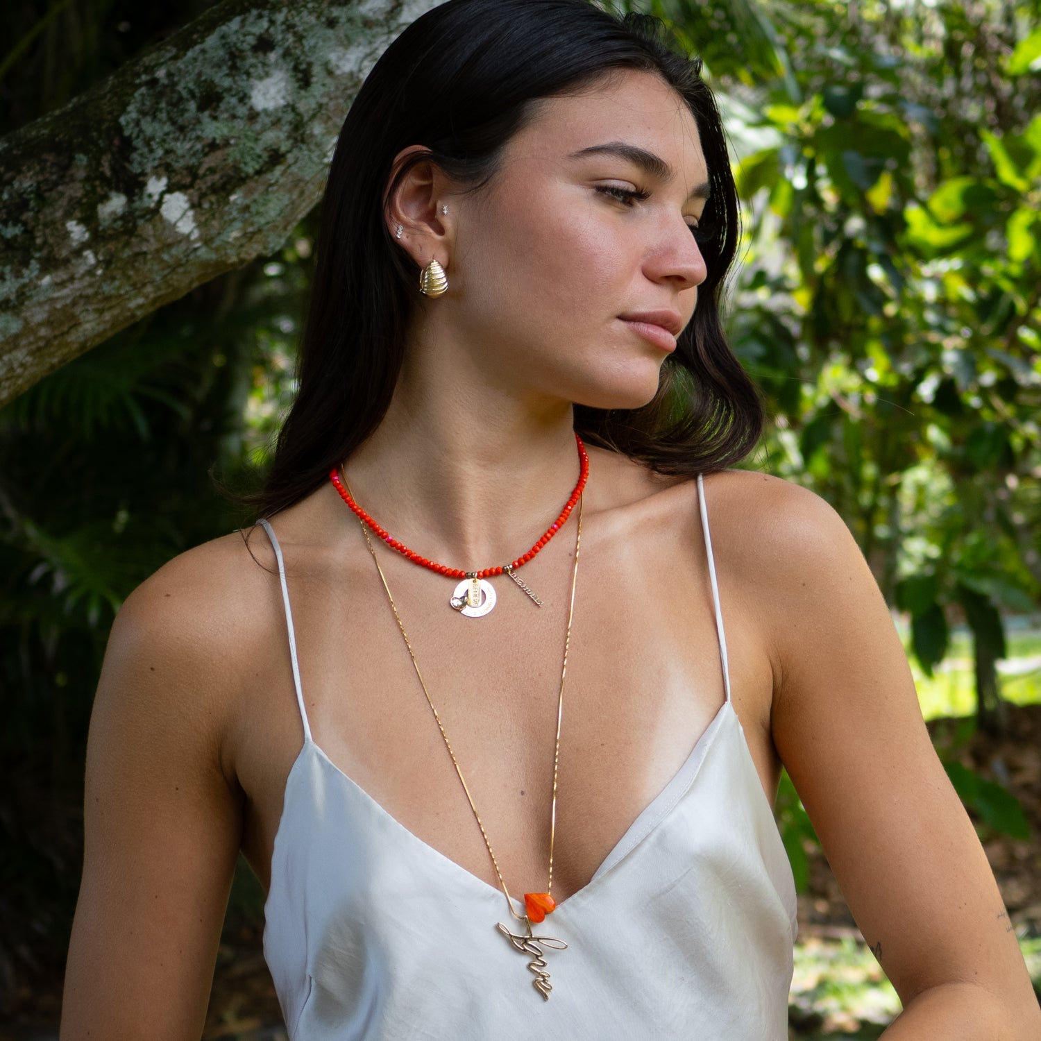 Red crystal choker necklace with adjustable extender and engraved affirmation charms.