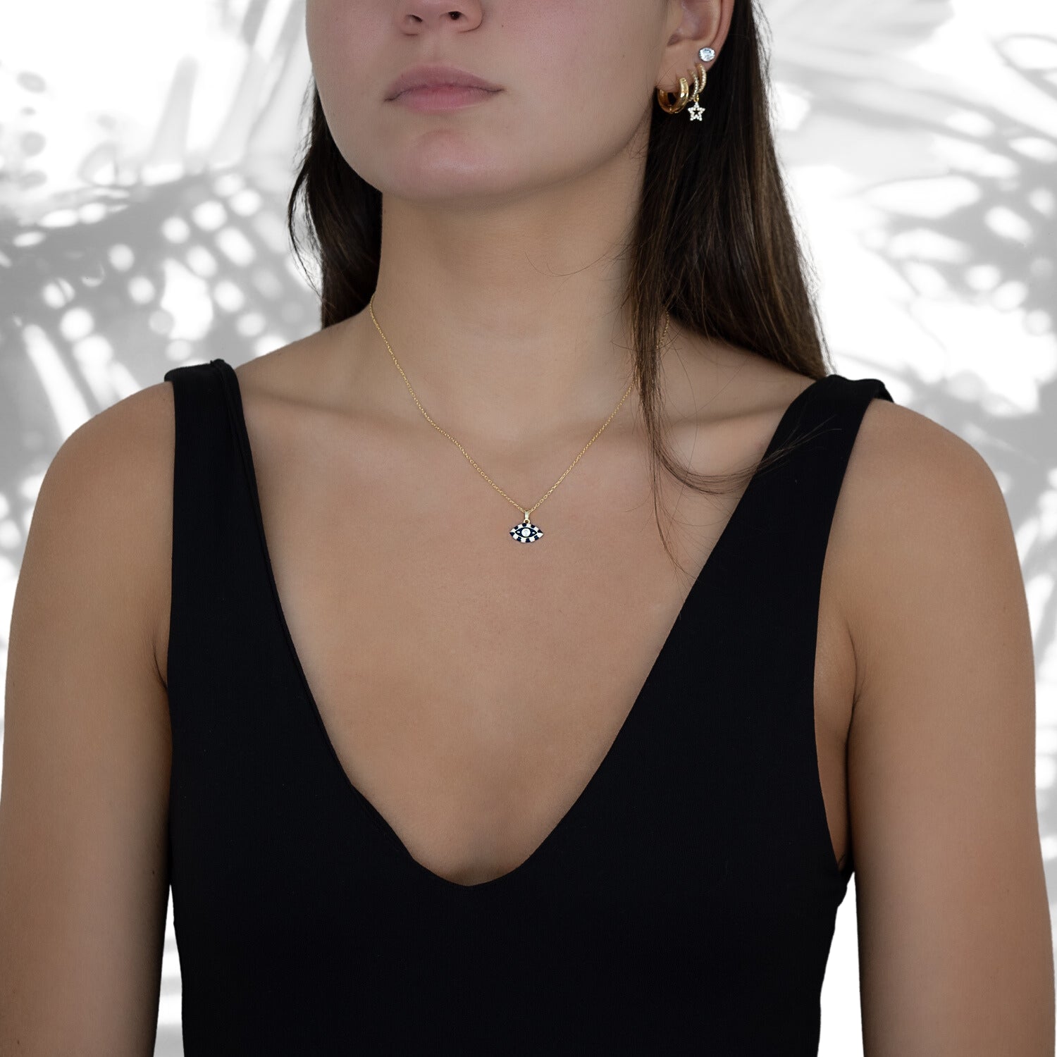 Stylish shot of a model wearing the Black And White Evil Eye Necklace, exuding confidence and showcasing the allure it adds to the overall ensemble.