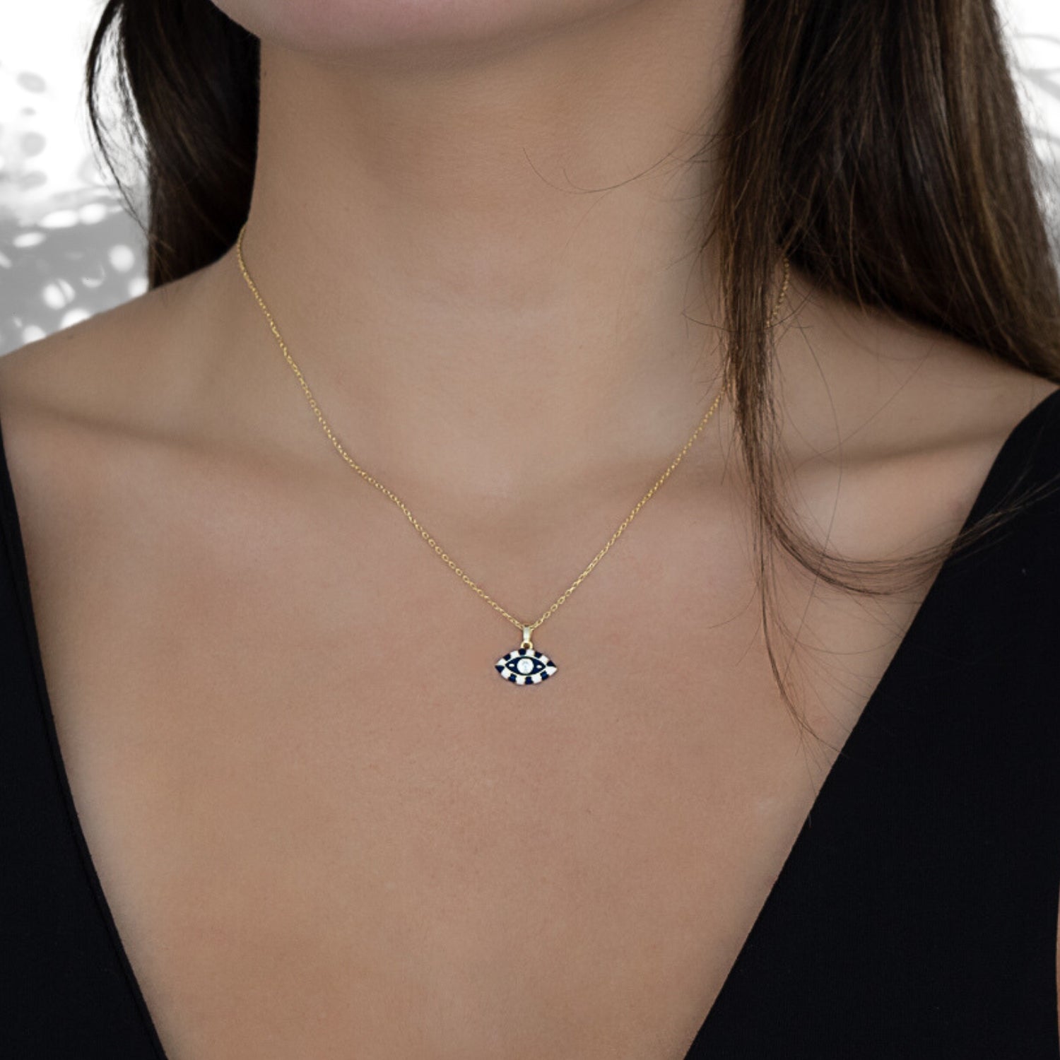 Model wearing the Black And White Evil Eye Necklace, showcasing the elegance and spiritual symbolism of the pendant.