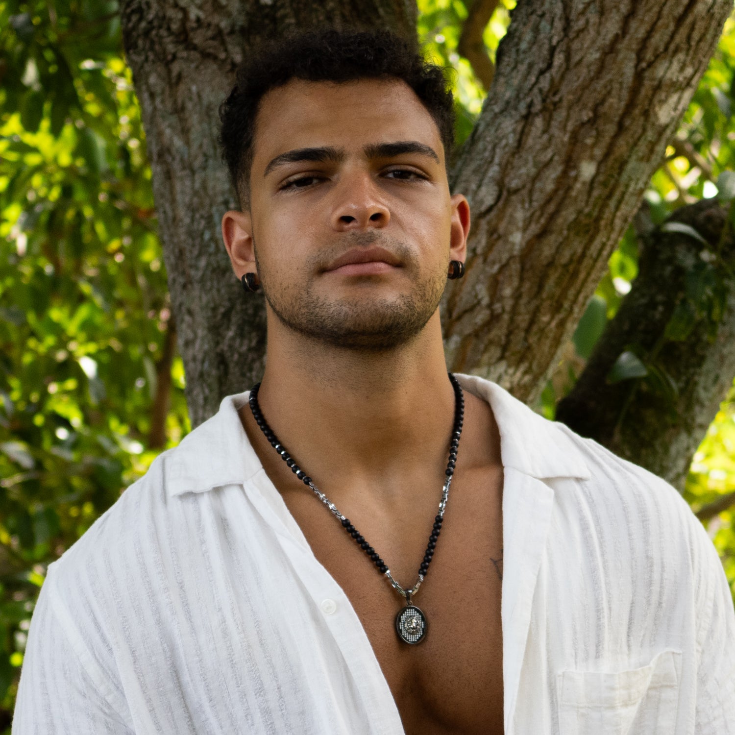 Masculine necklace with black onyx for protection and silver lion for courage and strength.