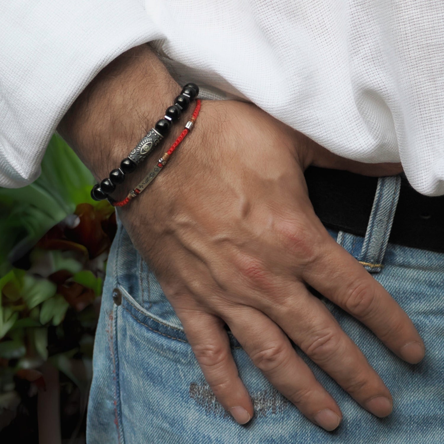 Handcrafted beaded bracelet featuring natural black onyx gemstones and a sterling silver Evil Eye bead.