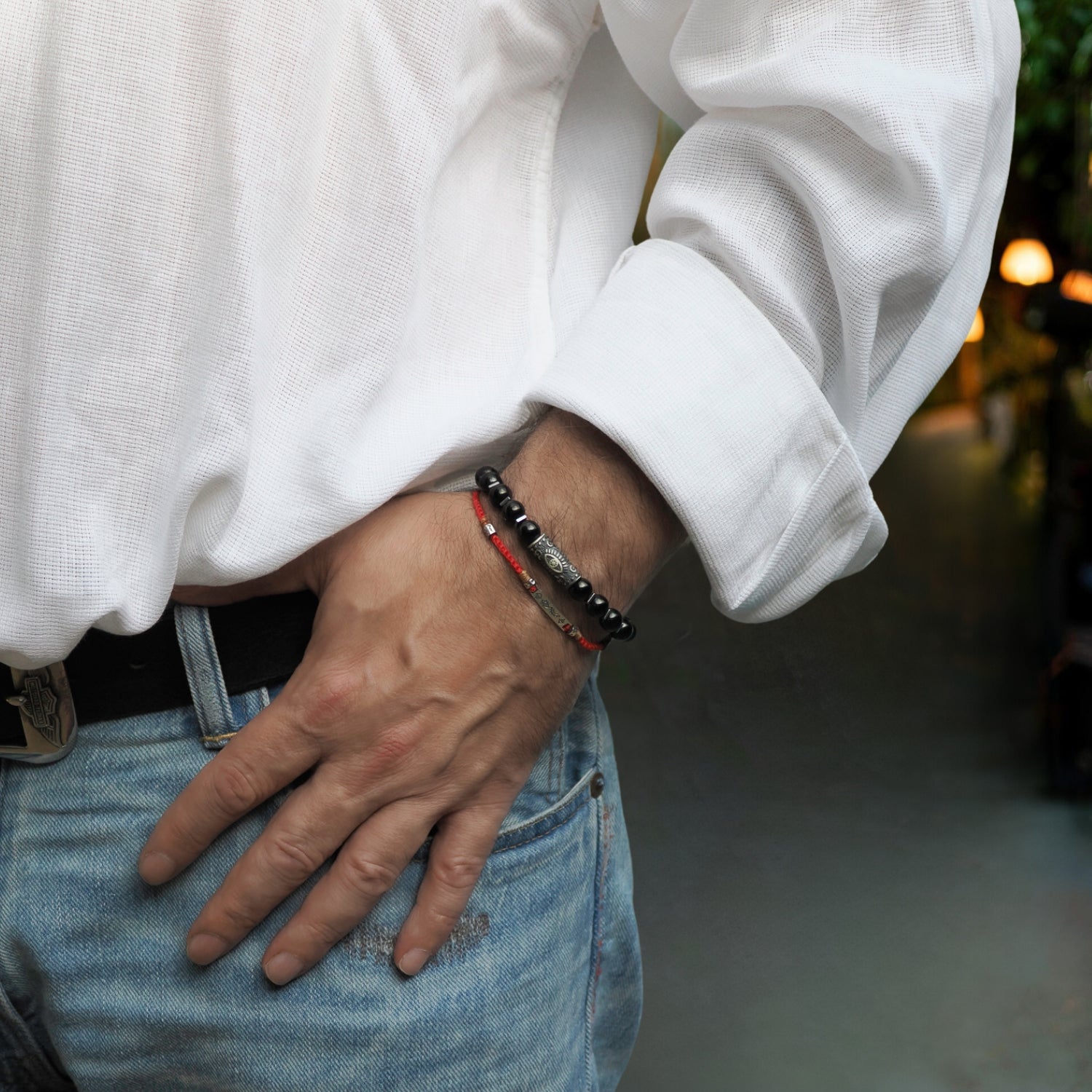Elegant black onyx beaded bracelet with a sterling silver Evil Eye charm for strength and emotional balance.