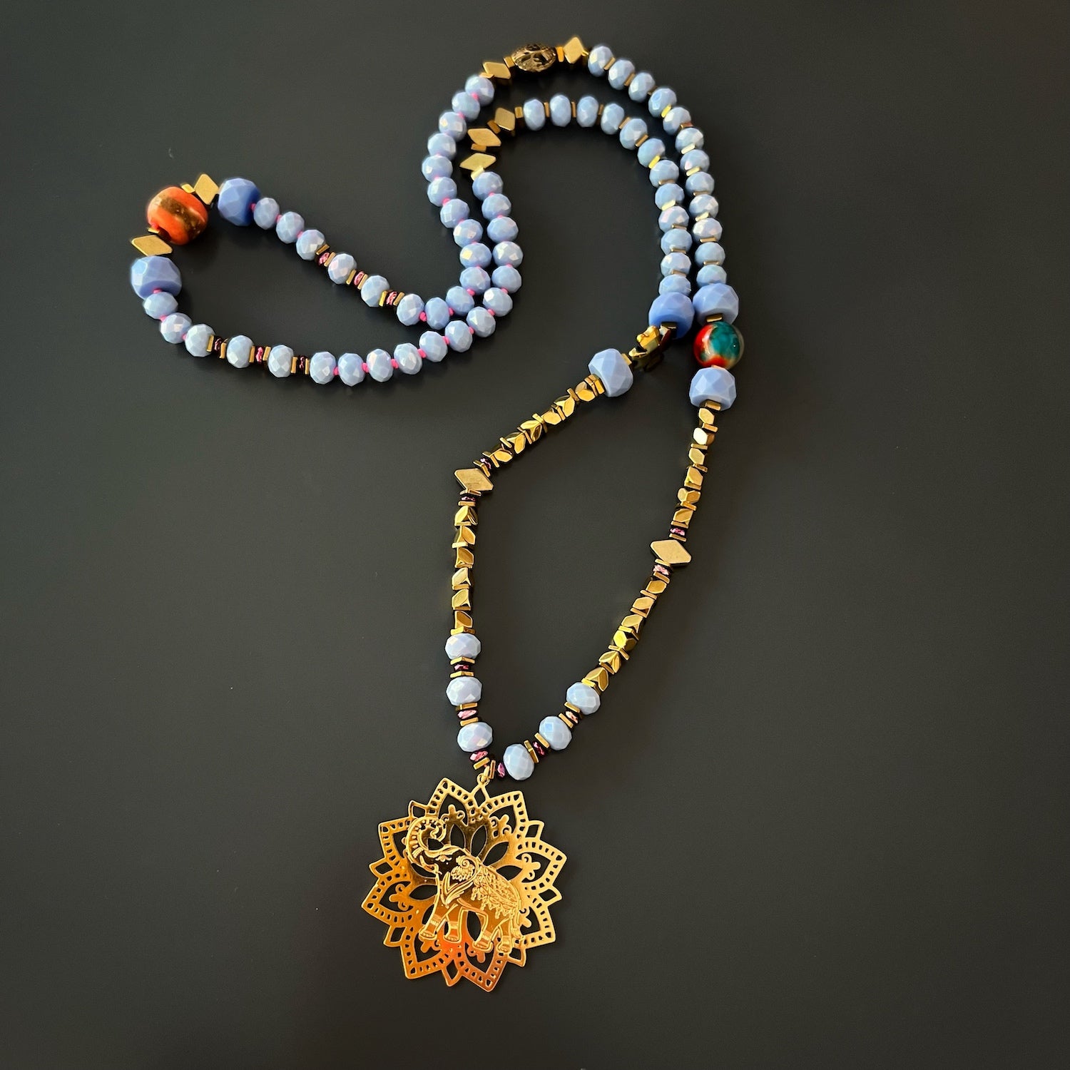 Blue Magic Gold Elephant Necklace, a stunning and elegant piece of jewelry that captures attention with its unique design and beautiful combination of beads.