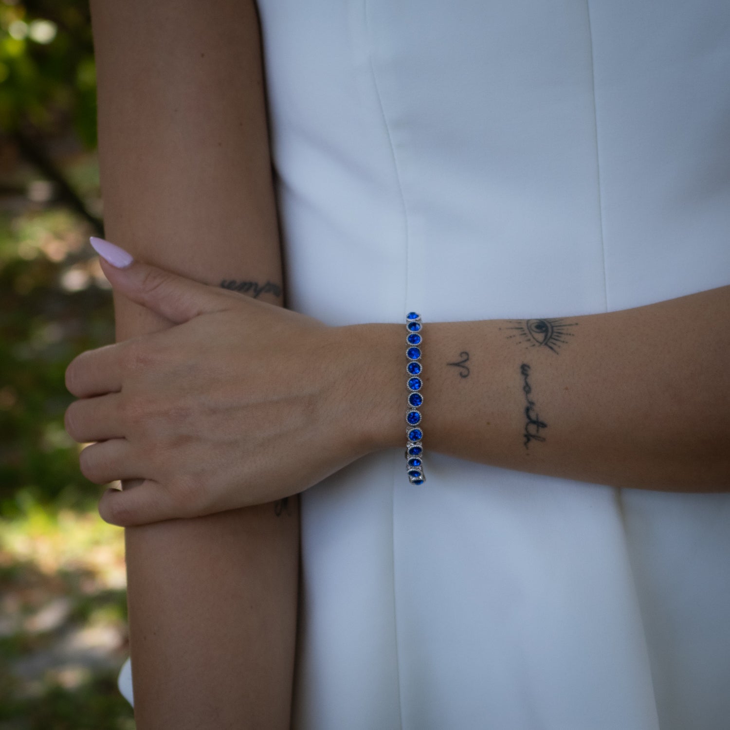 Blue Sapphire Tennis Bracelet with Mystic Engravings, Set in Silver-Plated Bronze for Timeless Elegance