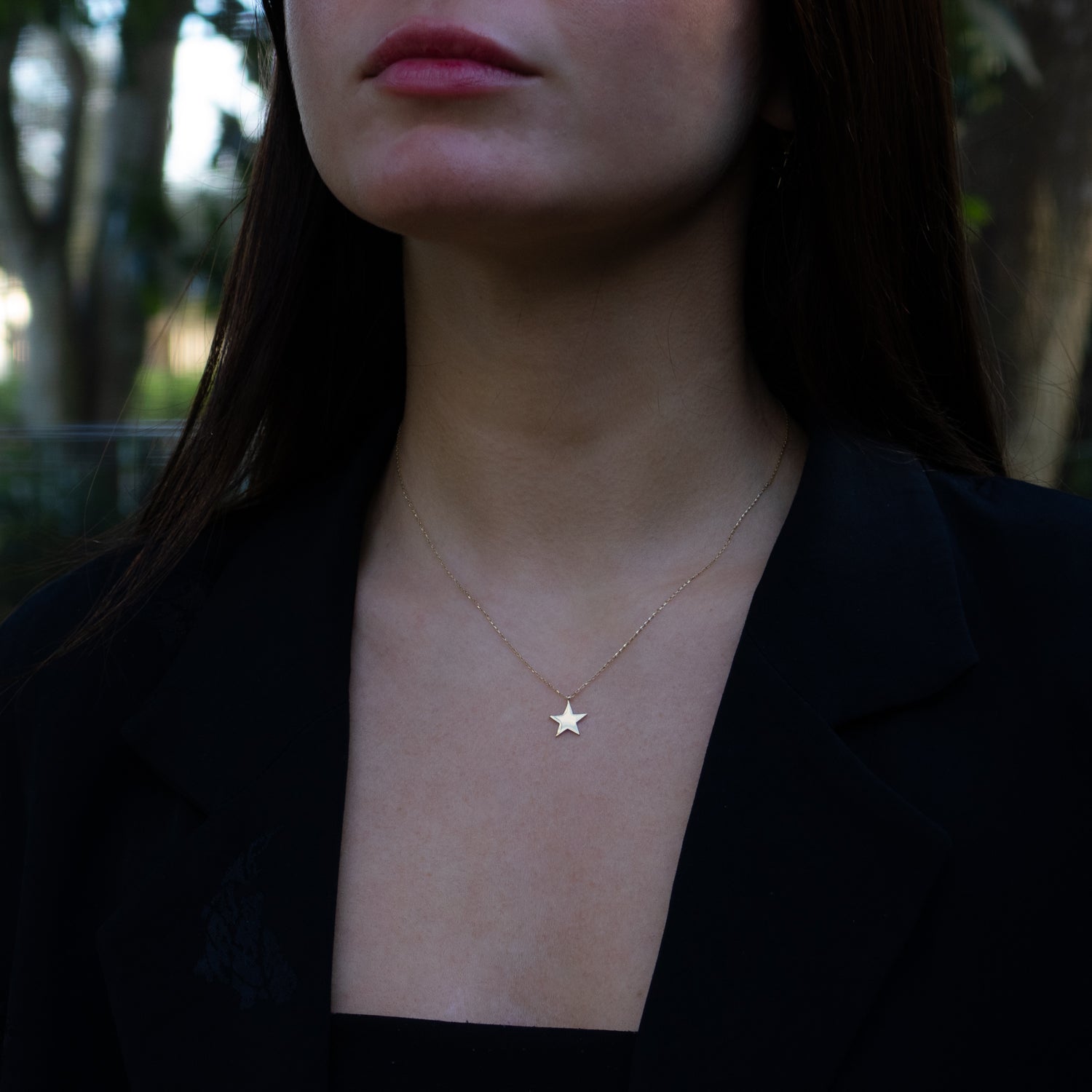 Close-up of 14K yellow gold star pendant necklace symbolizing hope