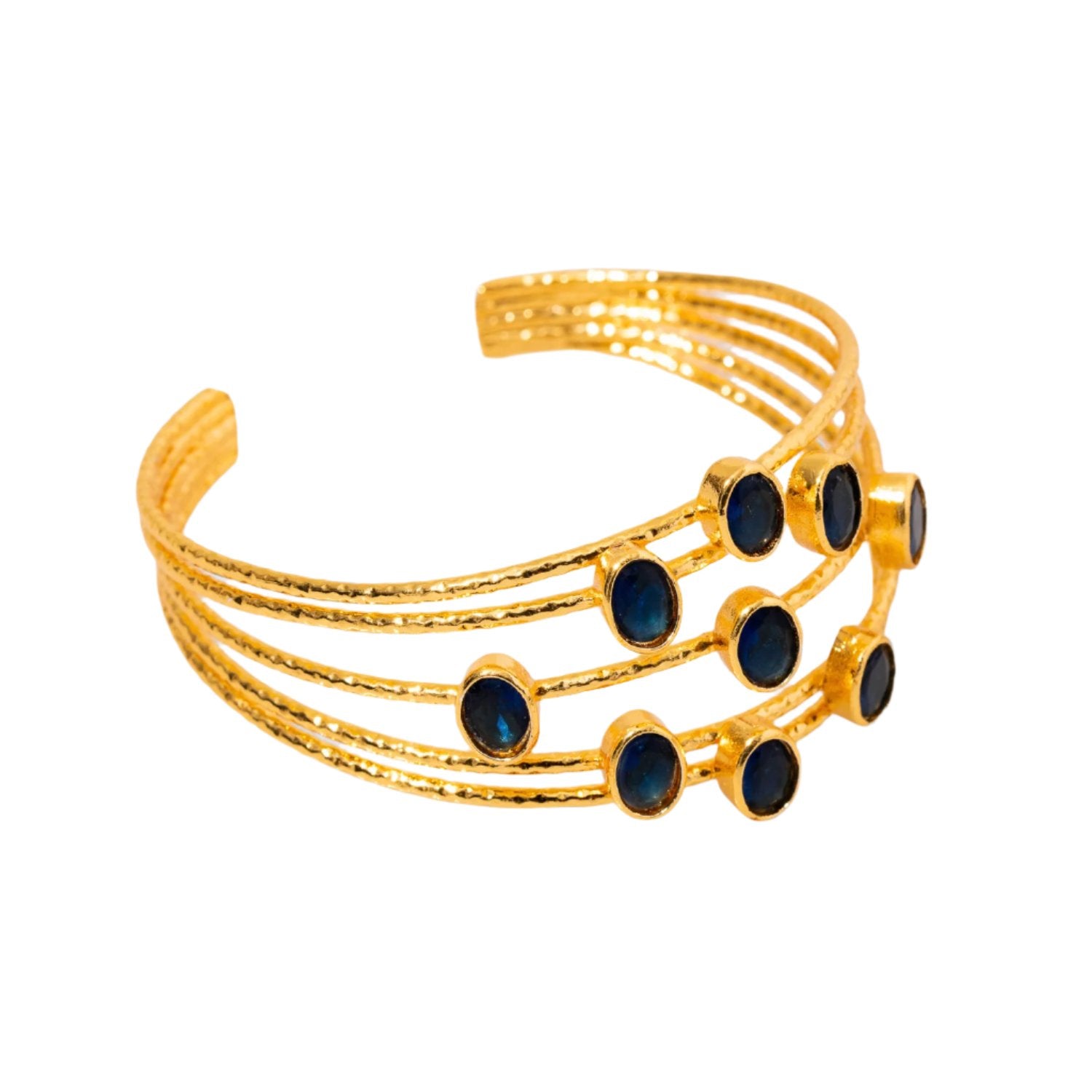 Sophisticated chunky cuff bracelet with 24k gold plating and sapphire stones, designed with five gold wires, adjustable fit.