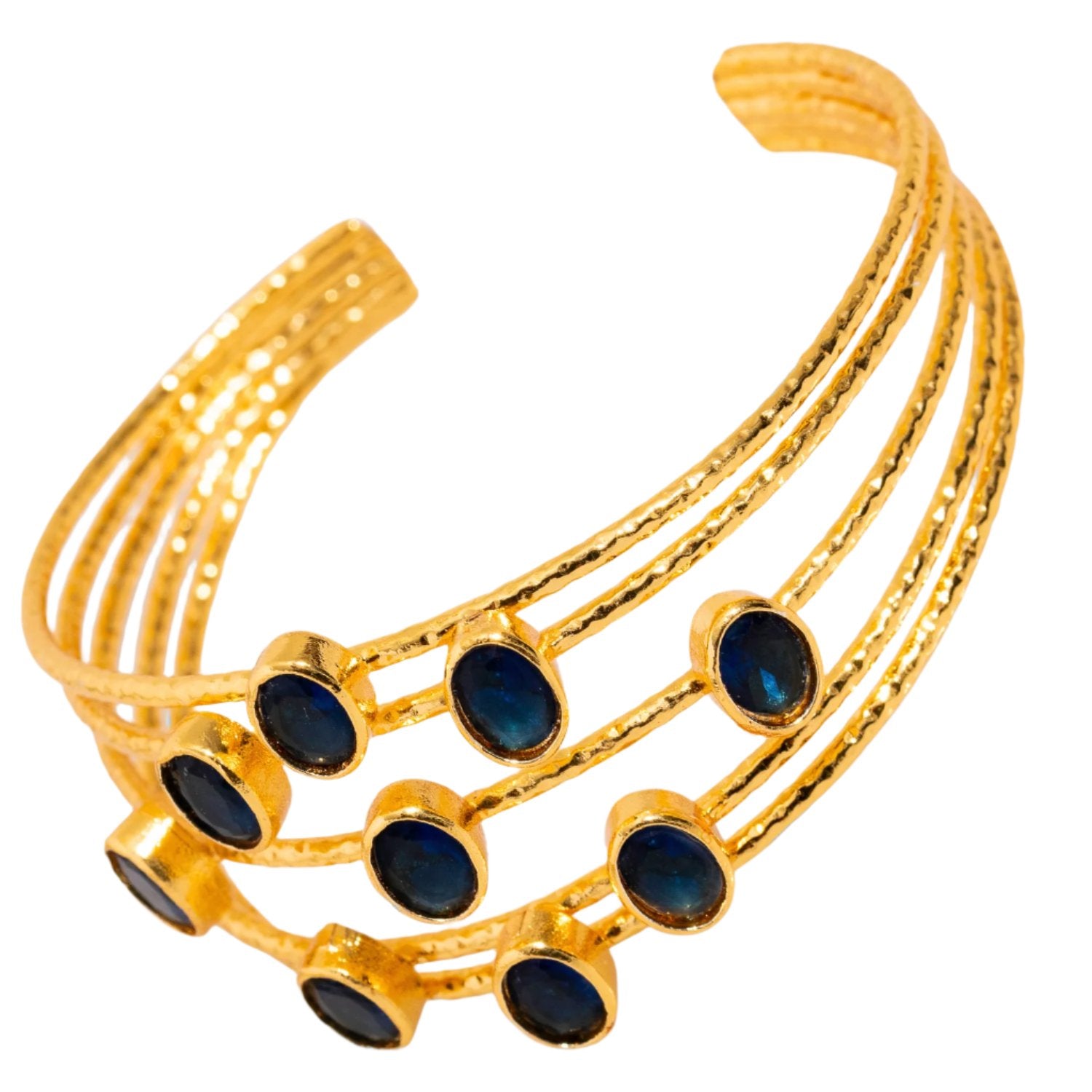 24k gold-plated chunky cuff bracelet with five gold wires and oval sapphire stones, offering a sophisticated and adjustable fit.
