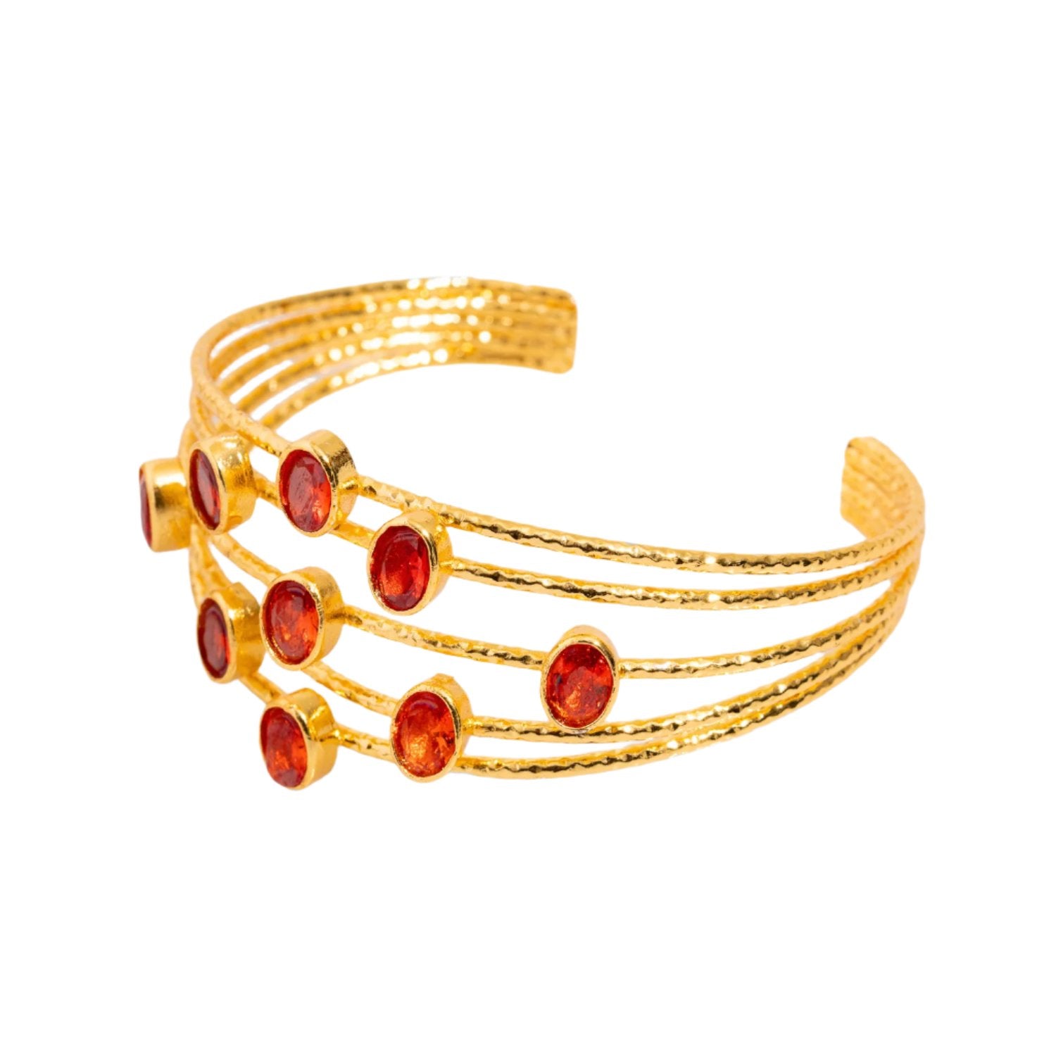 Chunky cuff bracelet with 24k gold plating and five thin gold wires, adorned with oval carnelian stones, adjustable size.
