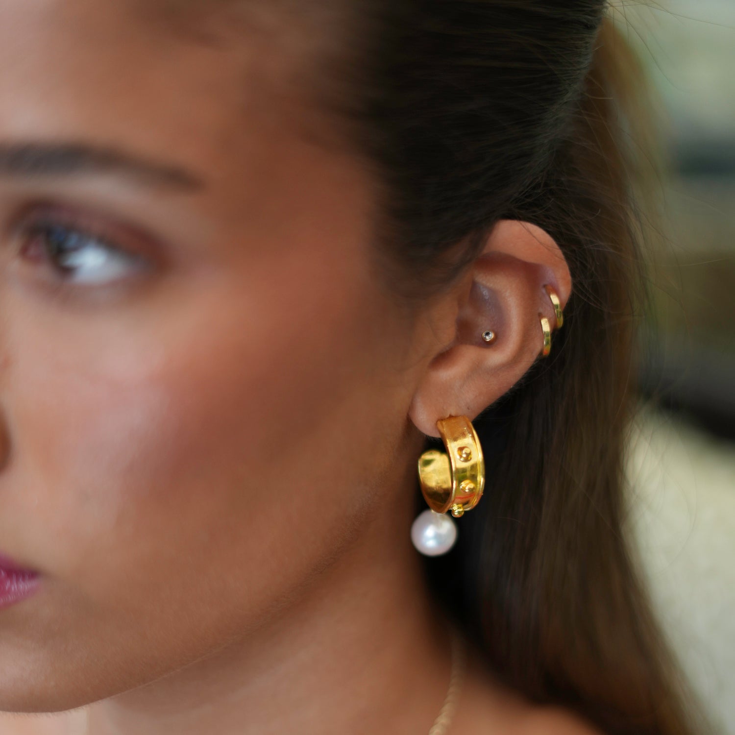Mystic 24k gold-plated hoop earrings featuring delicate pearl drops, offering timeless sophistication.