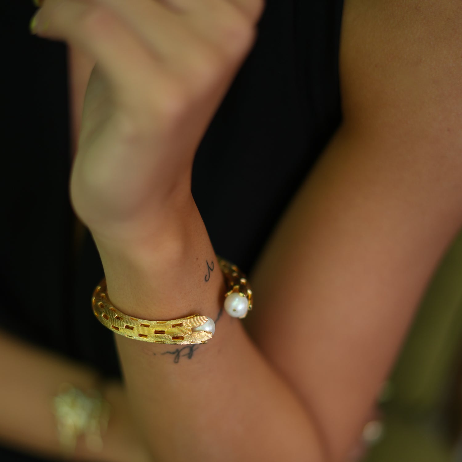 Gold Cuff Bracelet with Pearl Stones and Intricate Cutout Patterns for a Timeless Fashion Statement