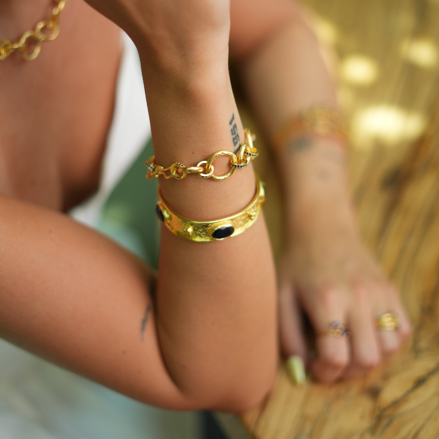 Intricate Gold Cuff Bracelet with Sapphire Stones for a Unique and Regal Fashion Accessory