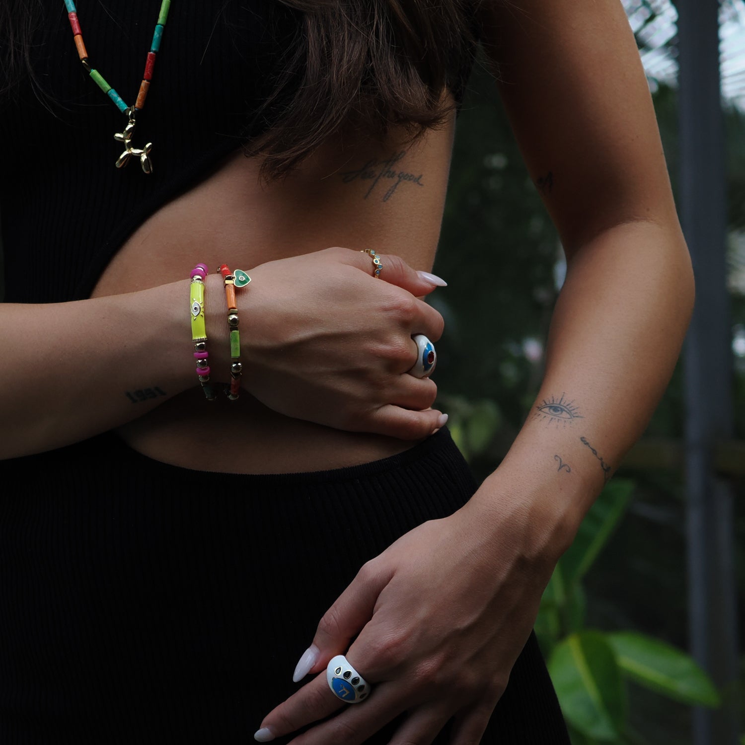 Colorful Jasper bracelet set adorned with a neon yellow Evil Eye tube and green enamel heart charm, symbolizing protection and love.