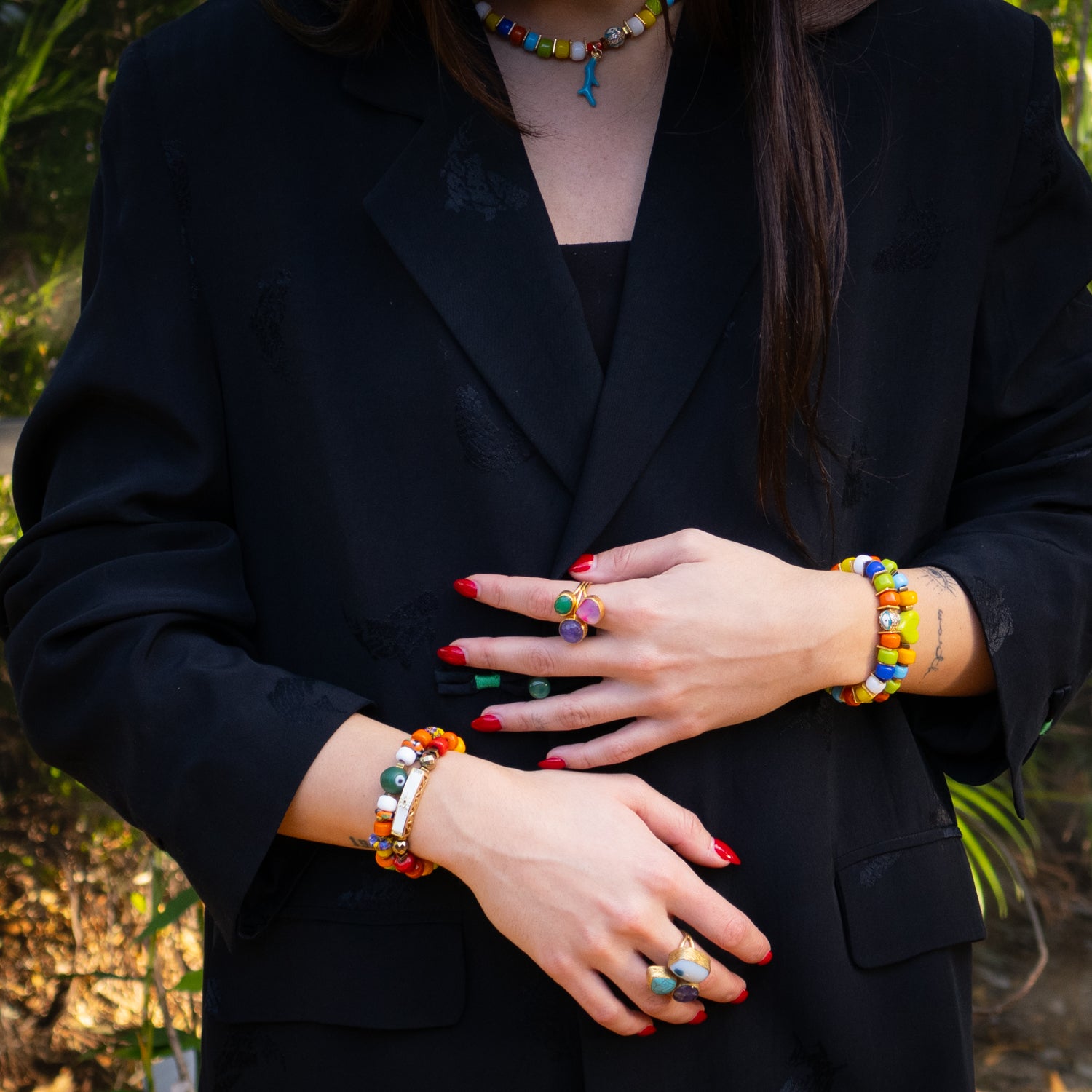 Wrist view of colorful evil eye bracelet duo perfect for beach style and positive energy