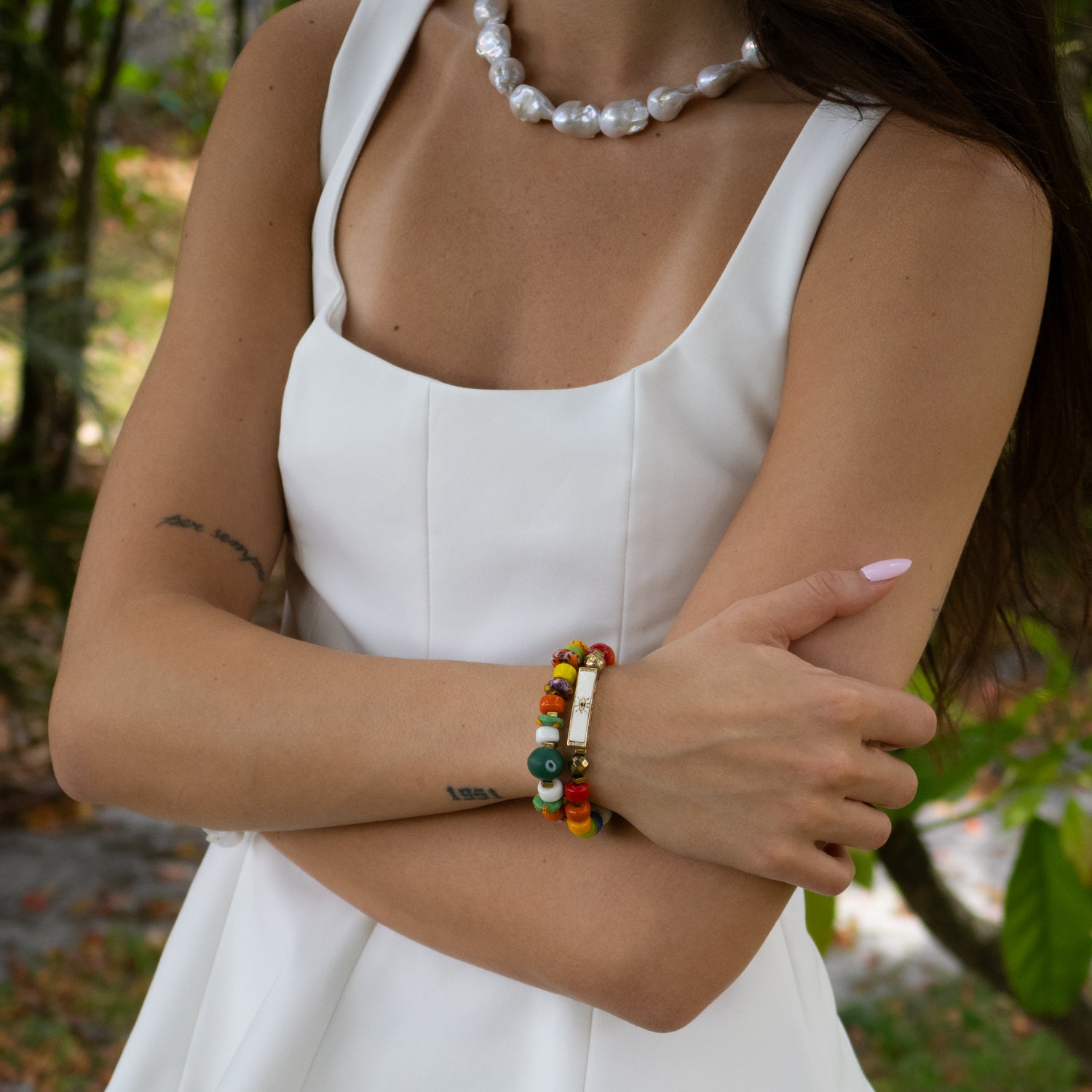 Close-up of multicolor ceramic bead bracelet with green evil eye center for protection