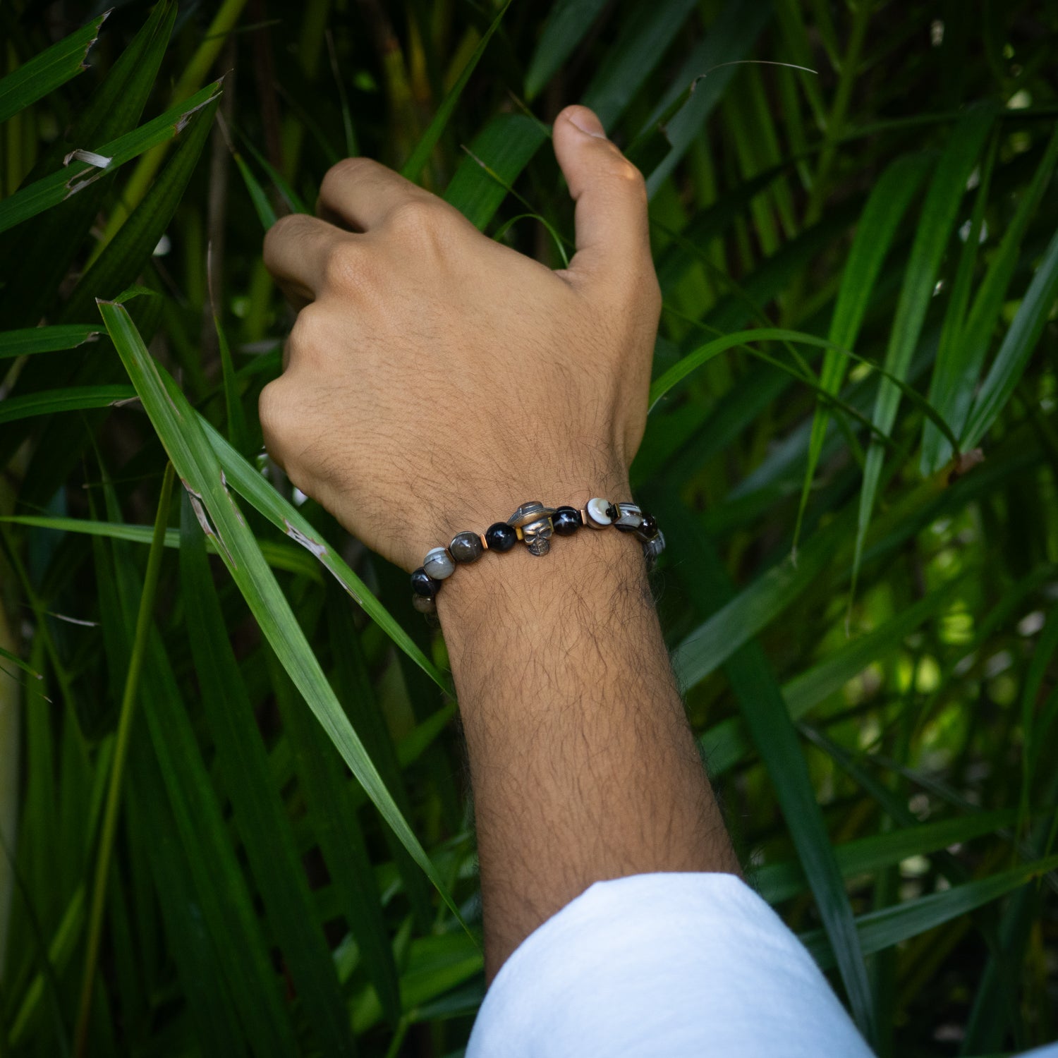 Handmade bracelet featuring 8mm agate stones, gold hematite, and unique skull centerpiece.