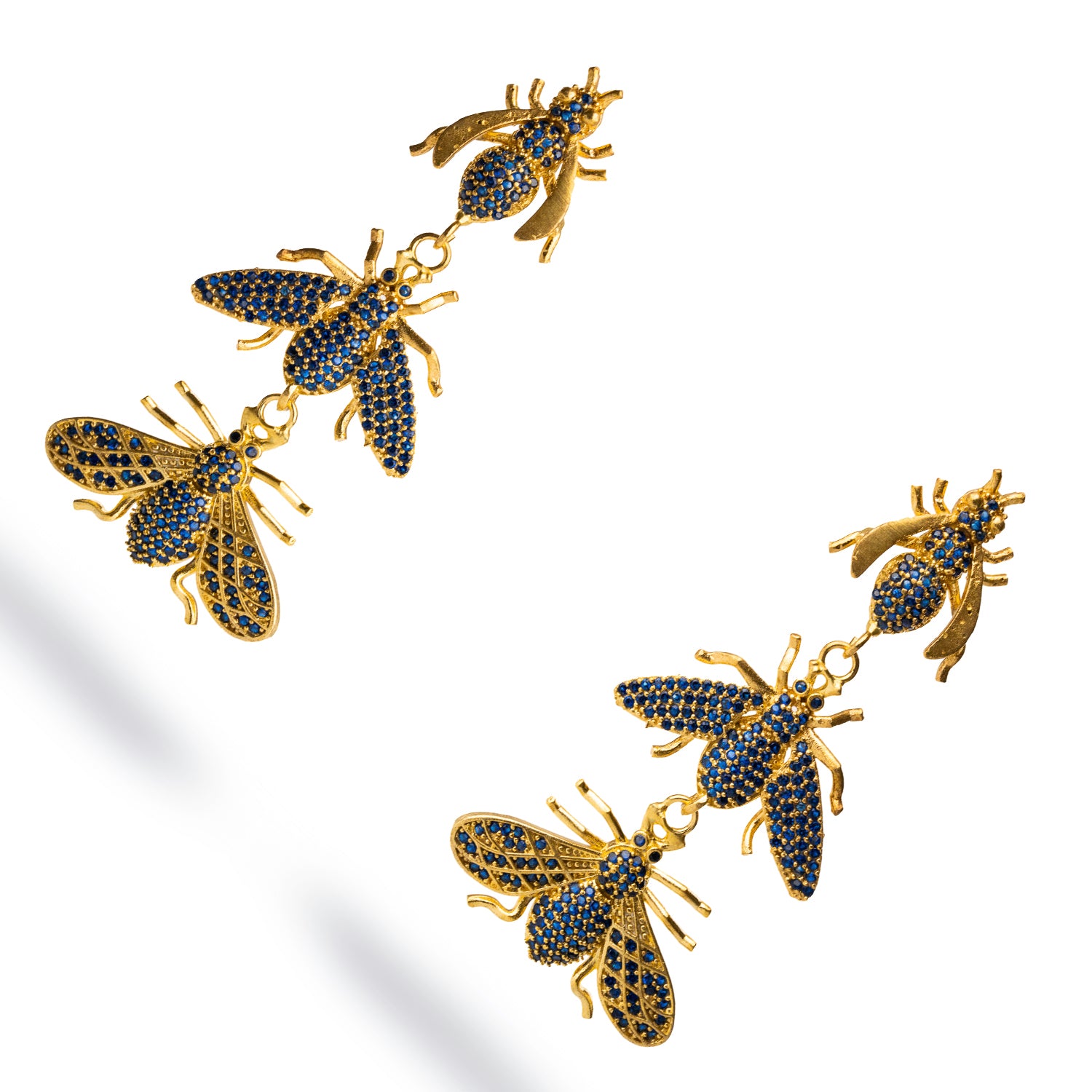 Striking 24k gold dangle earrings with three queen bee charms, each set with sapphire stones, radiating confidence and elegance.