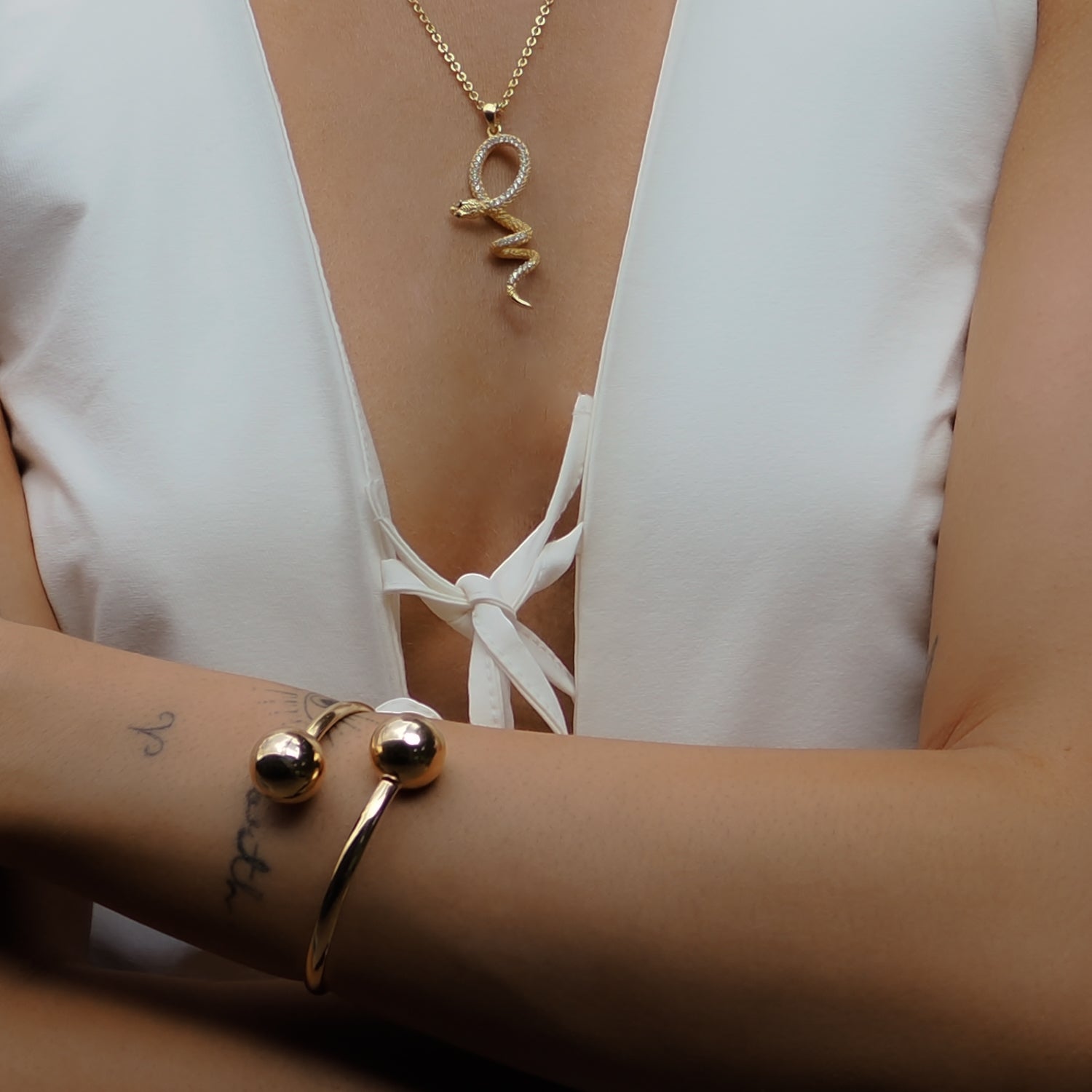 Handmade gold cuff bracelet featuring dual polished spheres and an adjustable, lightweight design.