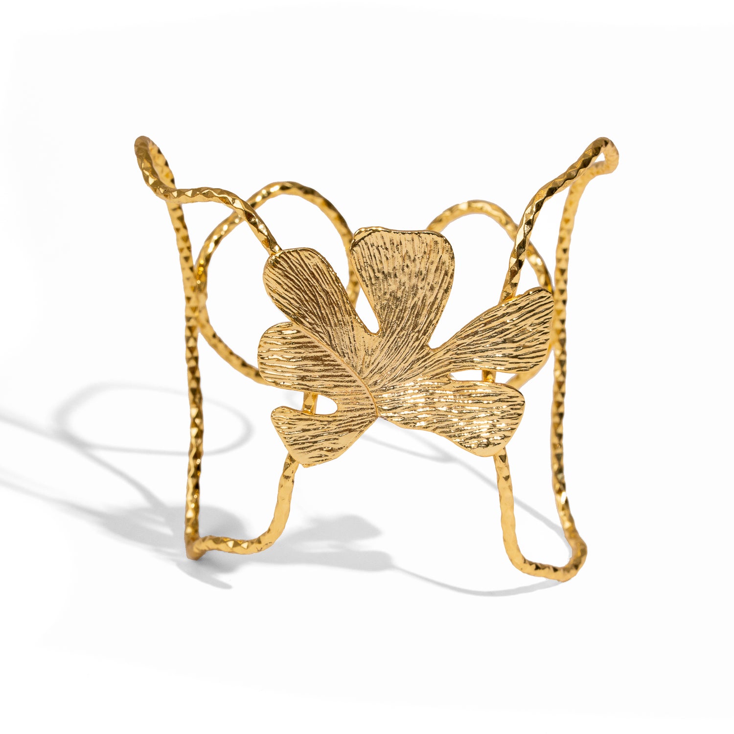 Gold butterfly-shaped jewelry on a white background